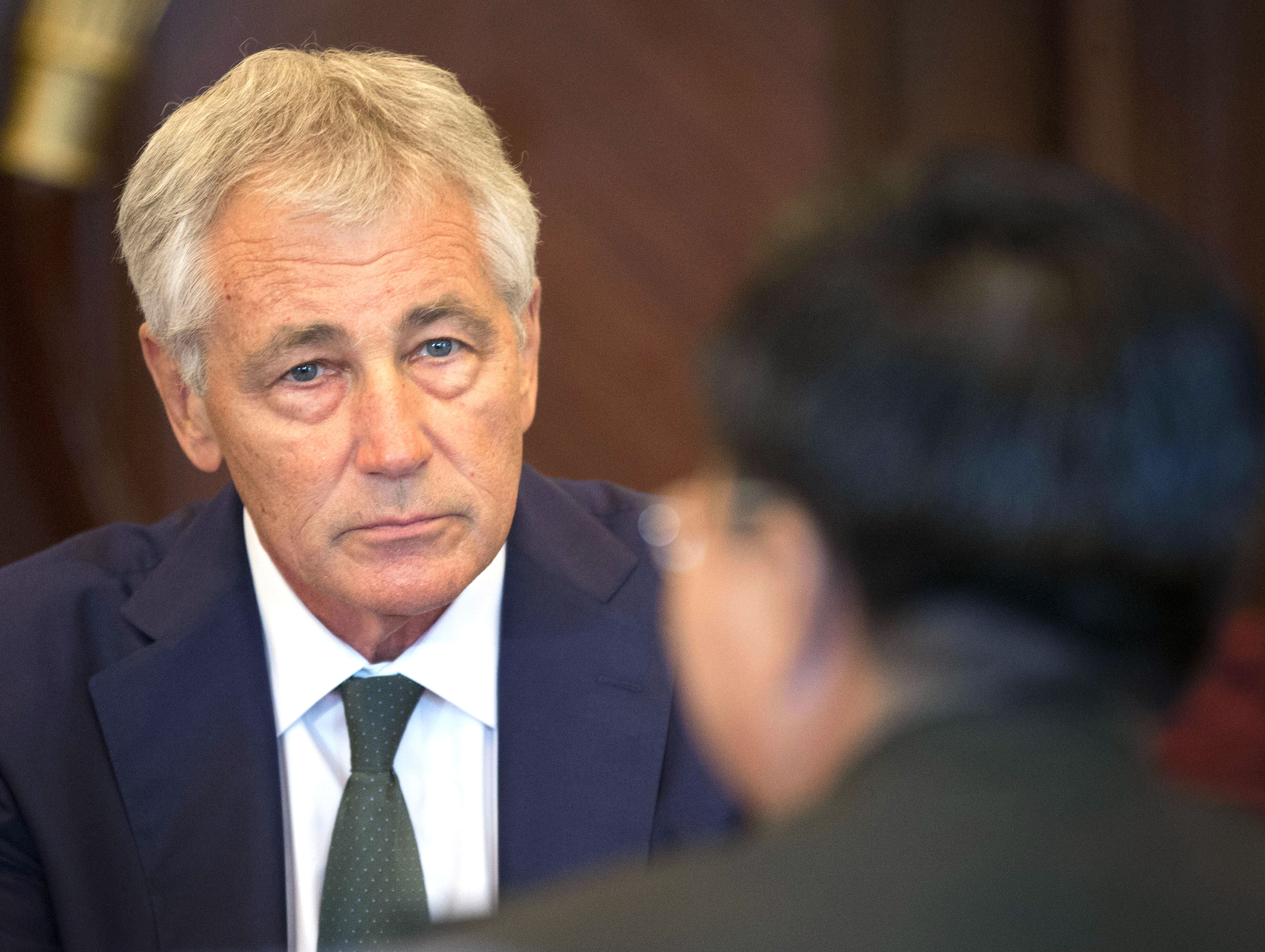 From left: U.S. Defense Secretary Chuck Hagel listens to Lt. Gen. Wang Guanzhong, China's deputy chief of General Staff during the start of their meeting on May 31, 2014 in Singapore.