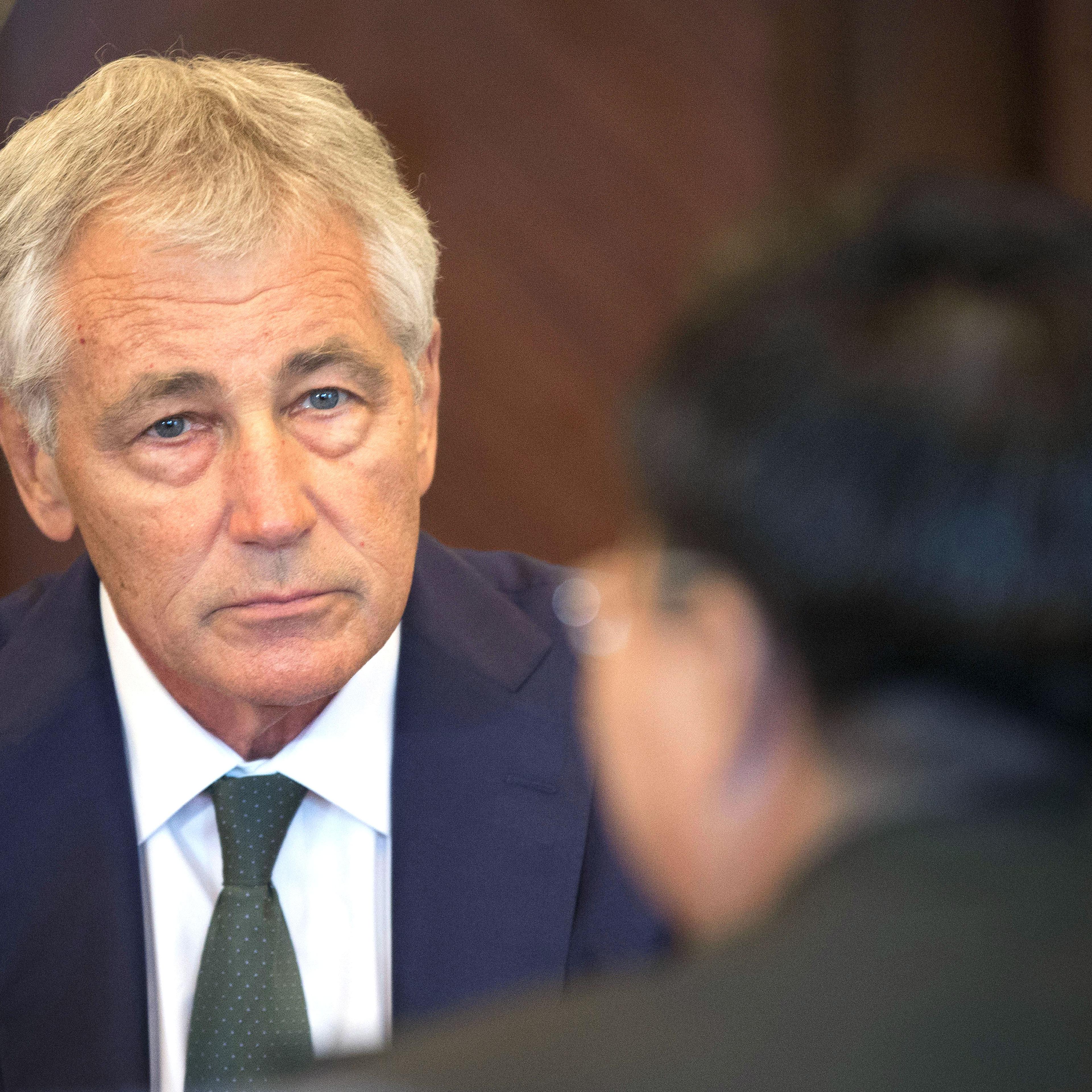From left: U.S. Defense Secretary Chuck Hagel listens to Lt. Gen. Wang Guanzhong, China's deputy chief of General Staff during the start of their meeting on May 31, 2014 in Singapore.