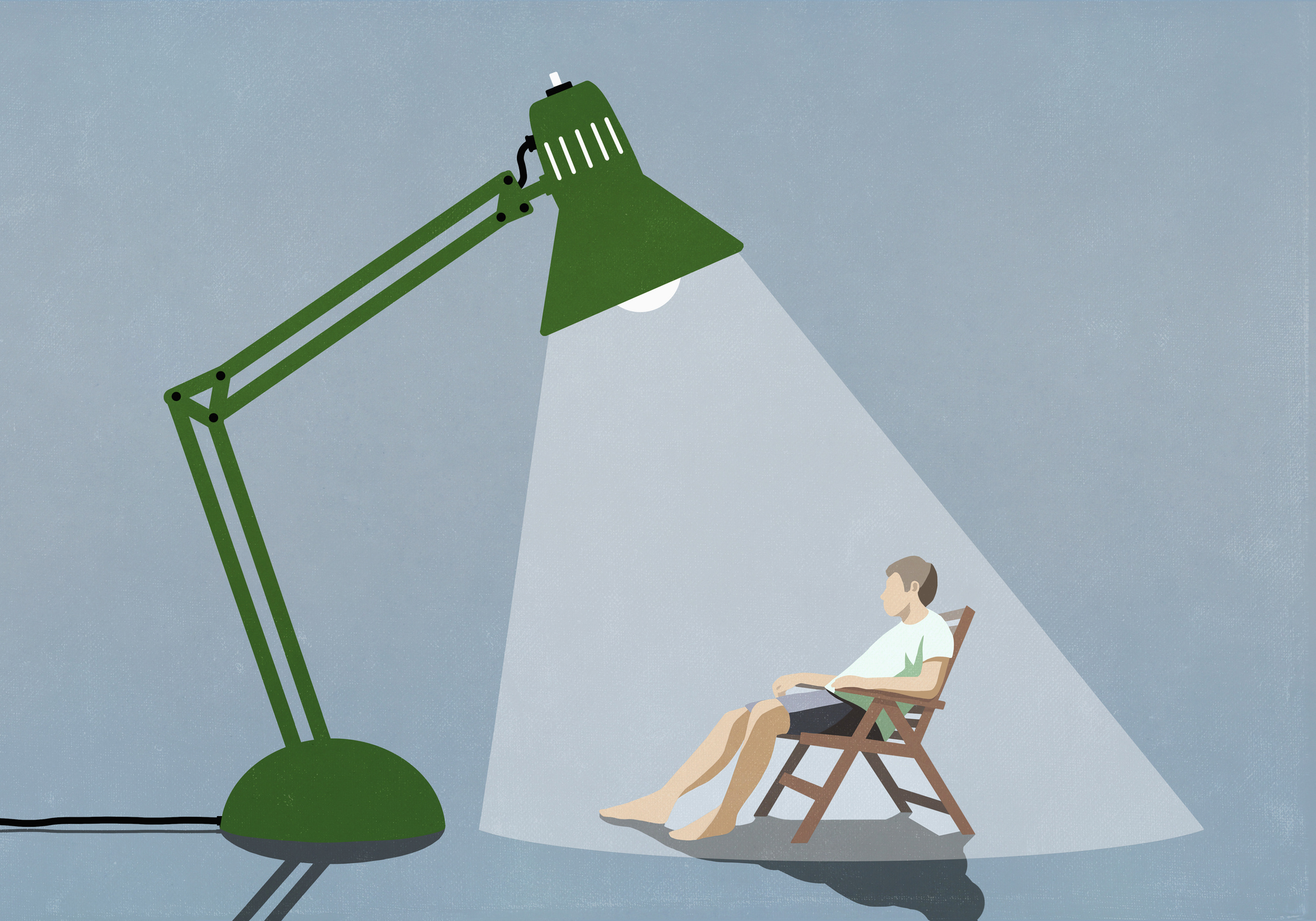 Man sitting under bright sun lamp
