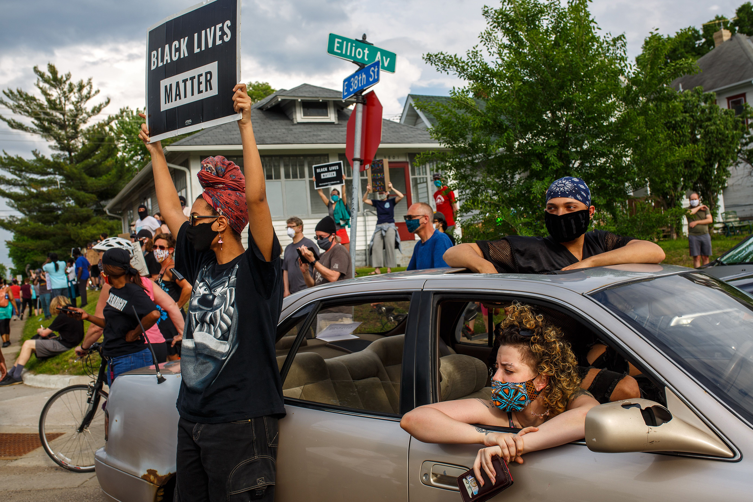 People hold signs and protest after a Minneapolis Police Department officer allegedly killed George Floyd, on May 26 in Minneapolis
