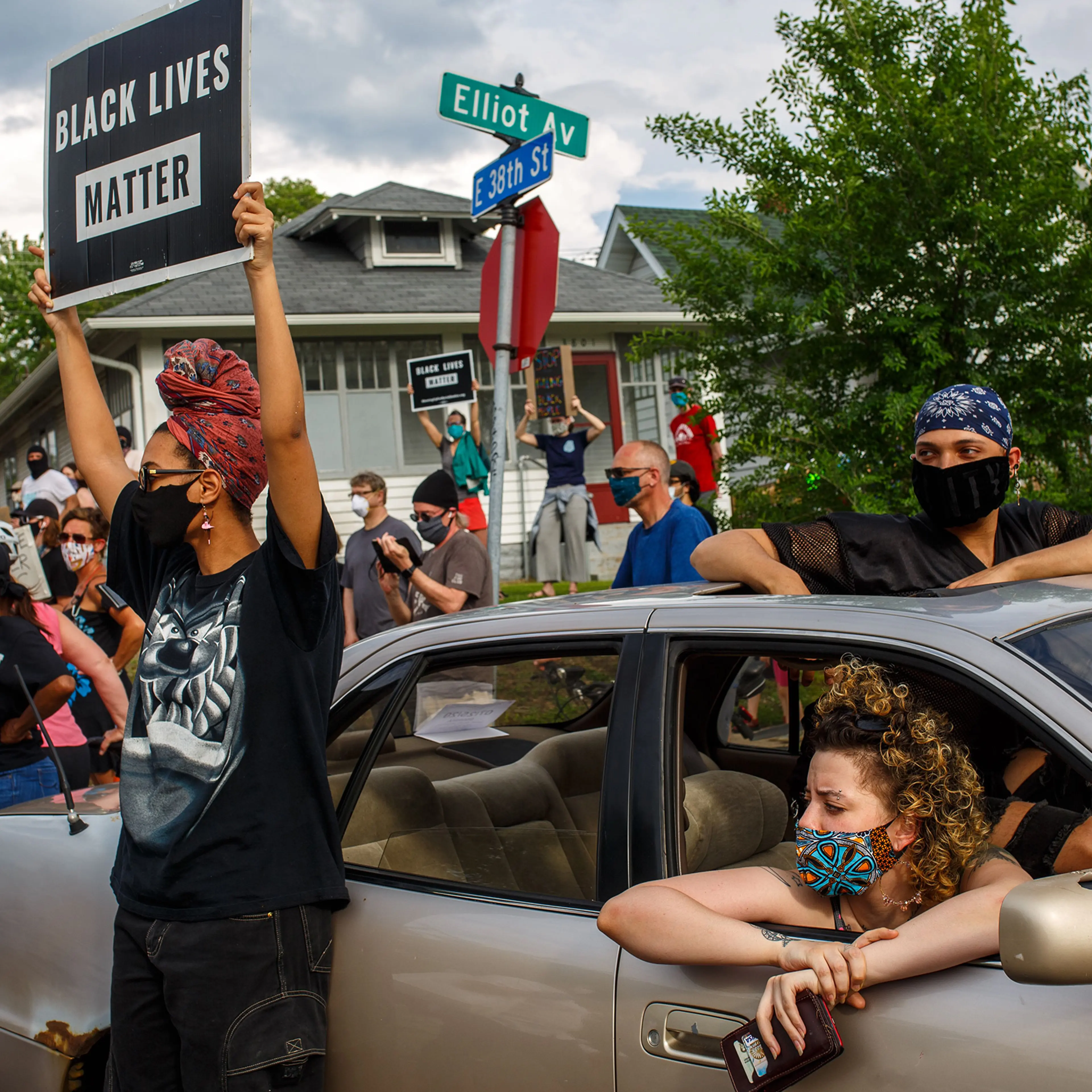 People hold signs and protest after a Minneapolis Police Department officer allegedly killed George Floyd, on May 26 in Minneapolis