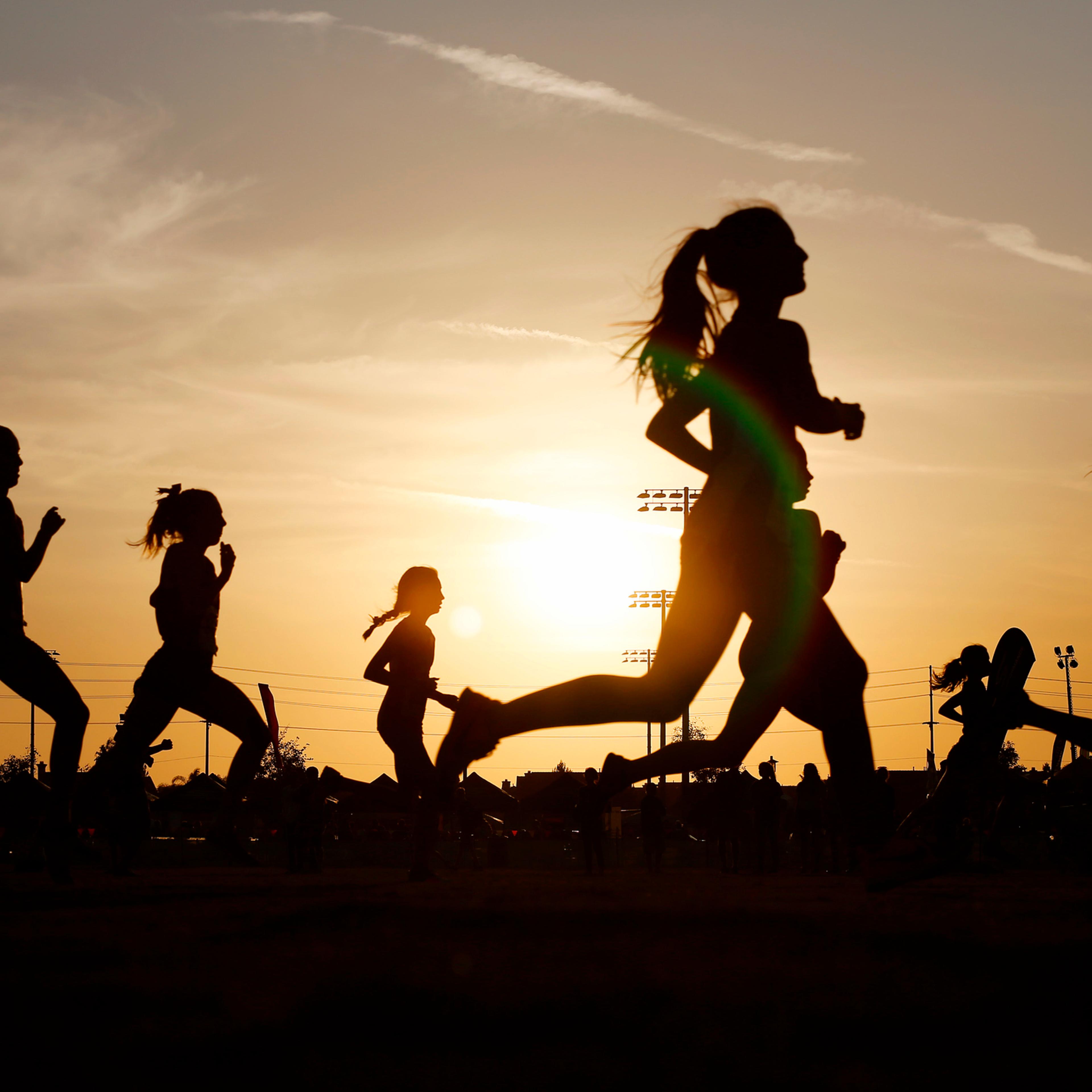 Runners compete in a 5k at sunset in Corona, California.