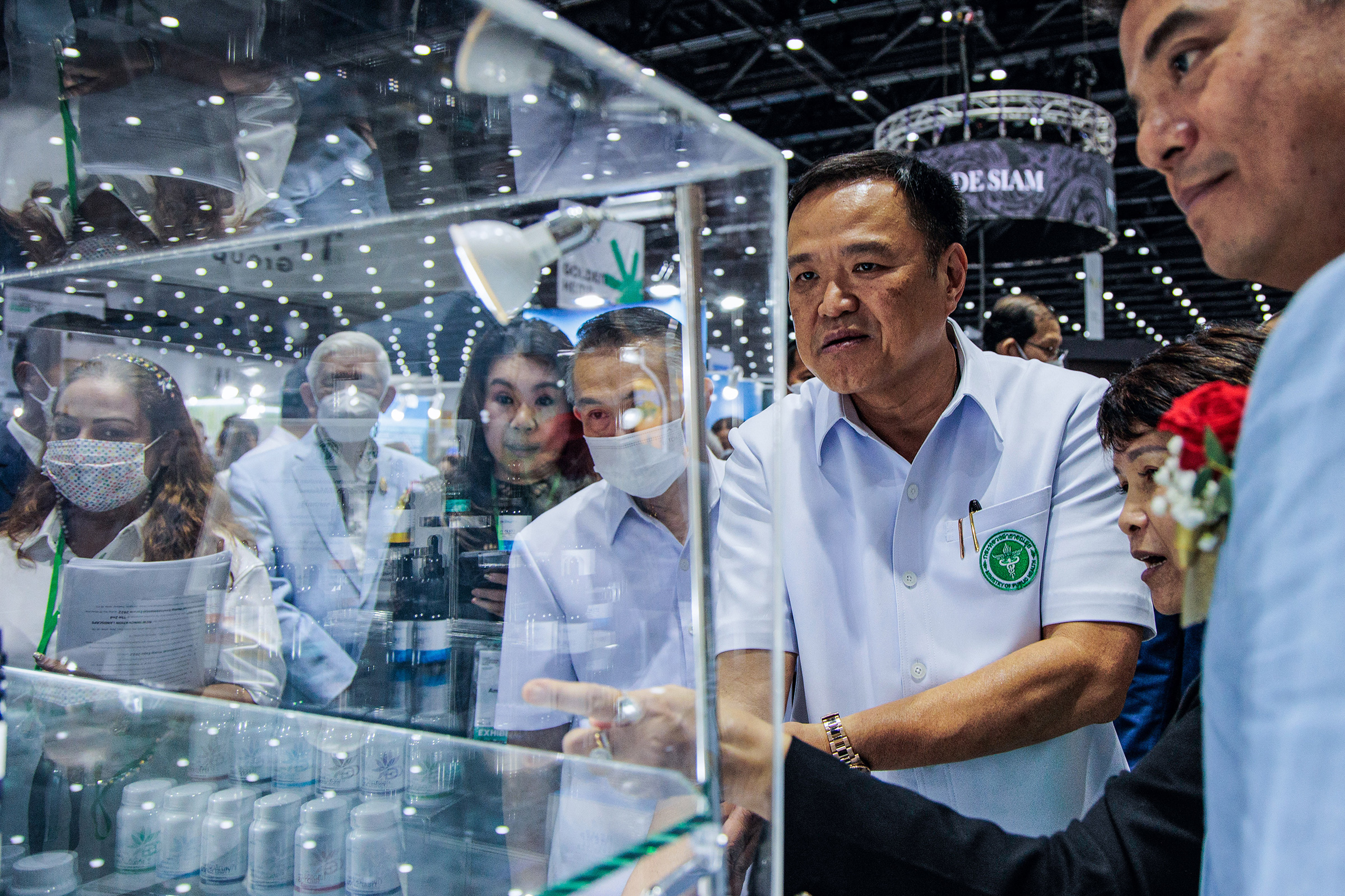 Anutin Charnvirakul stands in front of a cannabis oil shelf at the Asian Hemp Expo