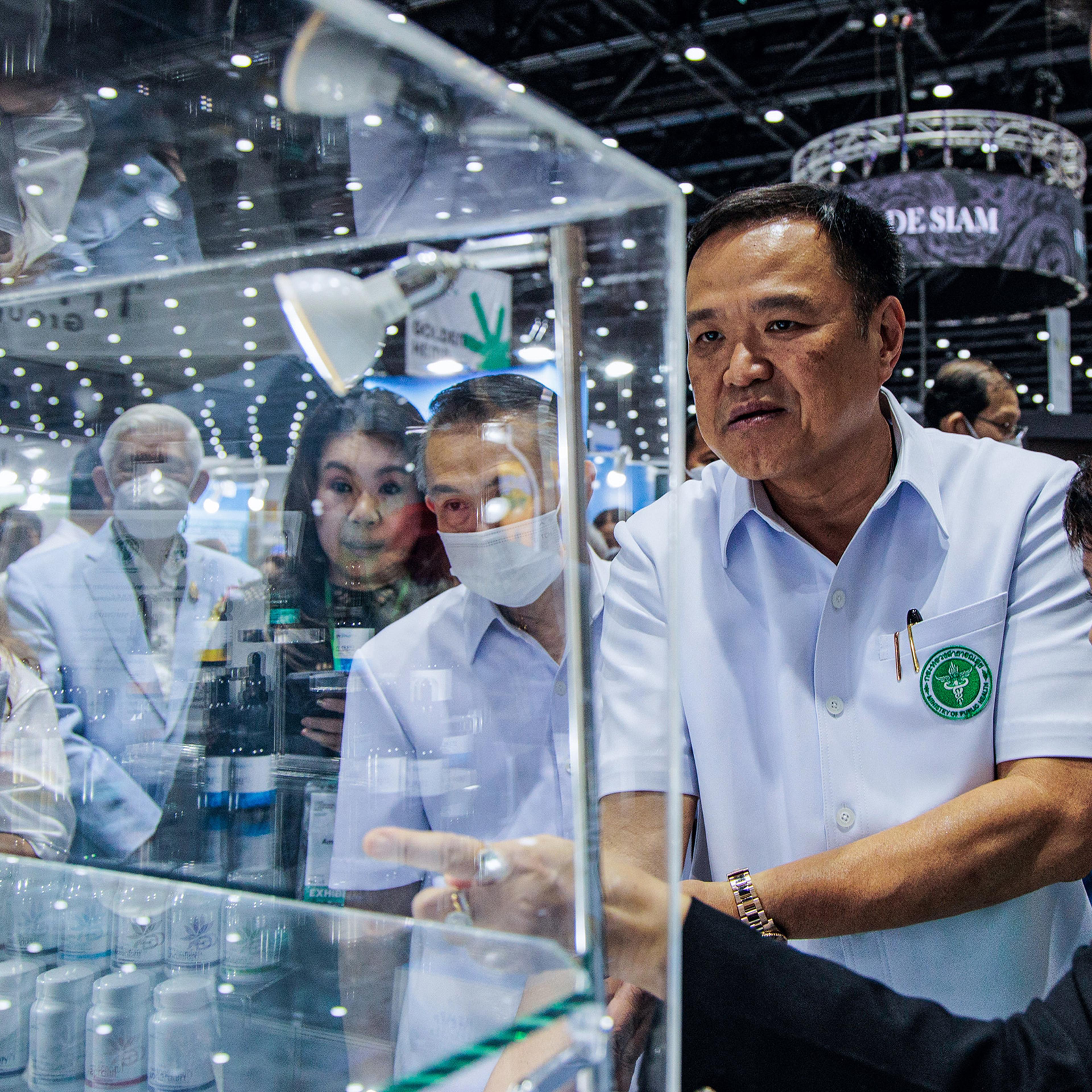 Anutin Charnvirakul stands in front of a cannabis oil shelf at the Asian Hemp Expo