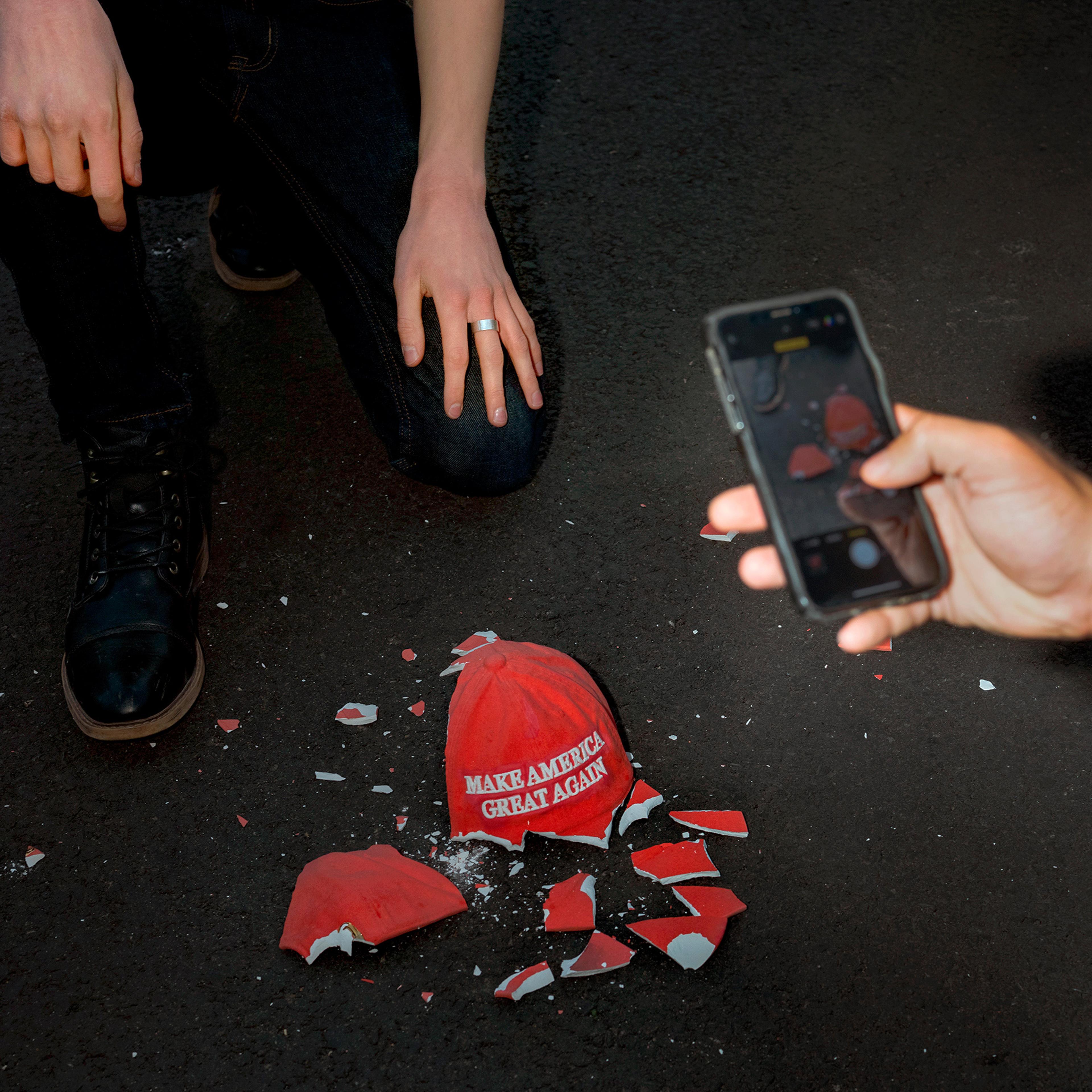 A protestor in Washington, D.C. breaks a ceramic MAGA hat on Nov. 4