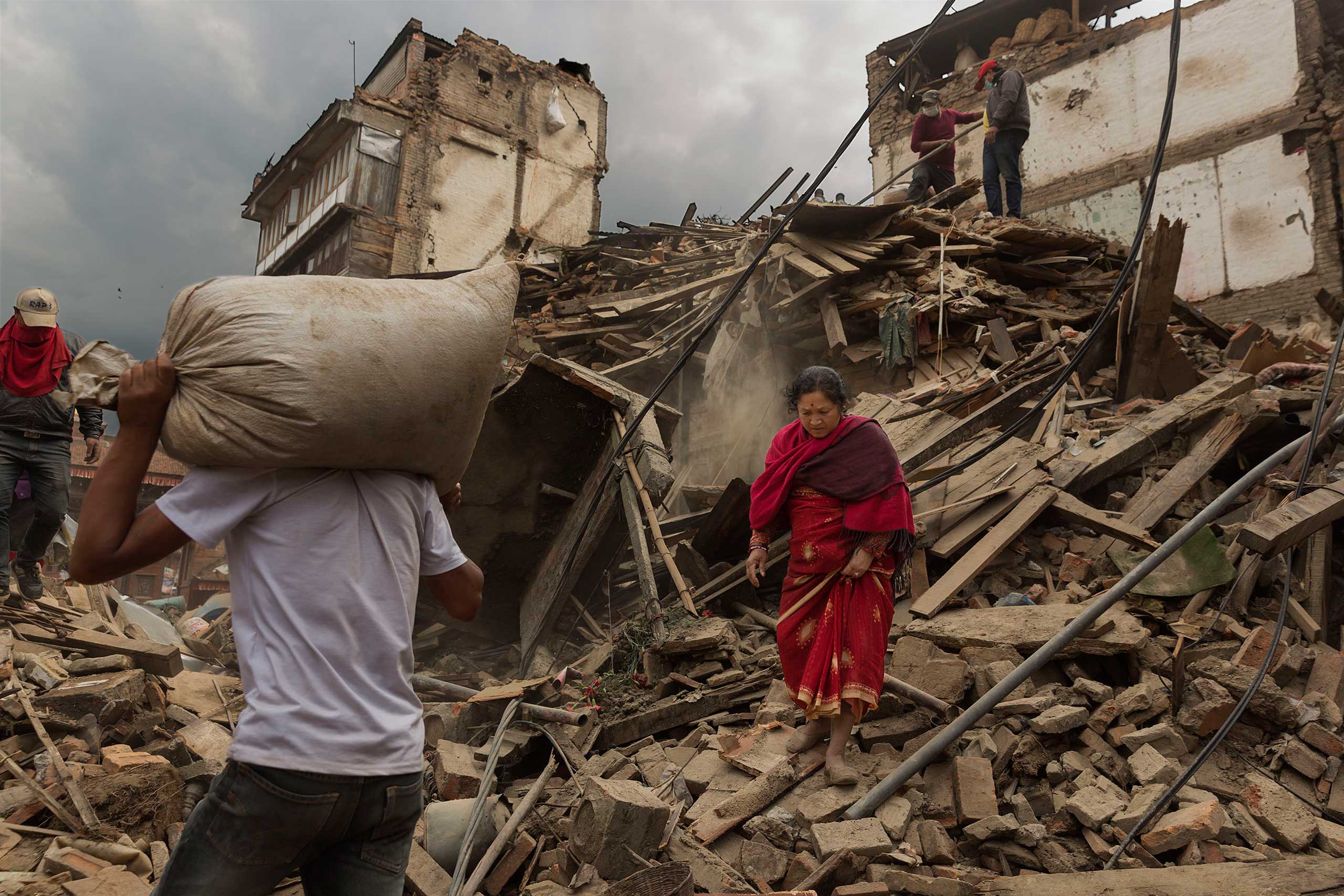 Nepal earthquake. Bhaktapur. A city near Katmandu. People reclaiming their possessions from the wreckage. A man who had been buried and died being pulled out of the wreckage by there Nepali Army rescue team. Sculpture of elephant in ruins of an ancient, 