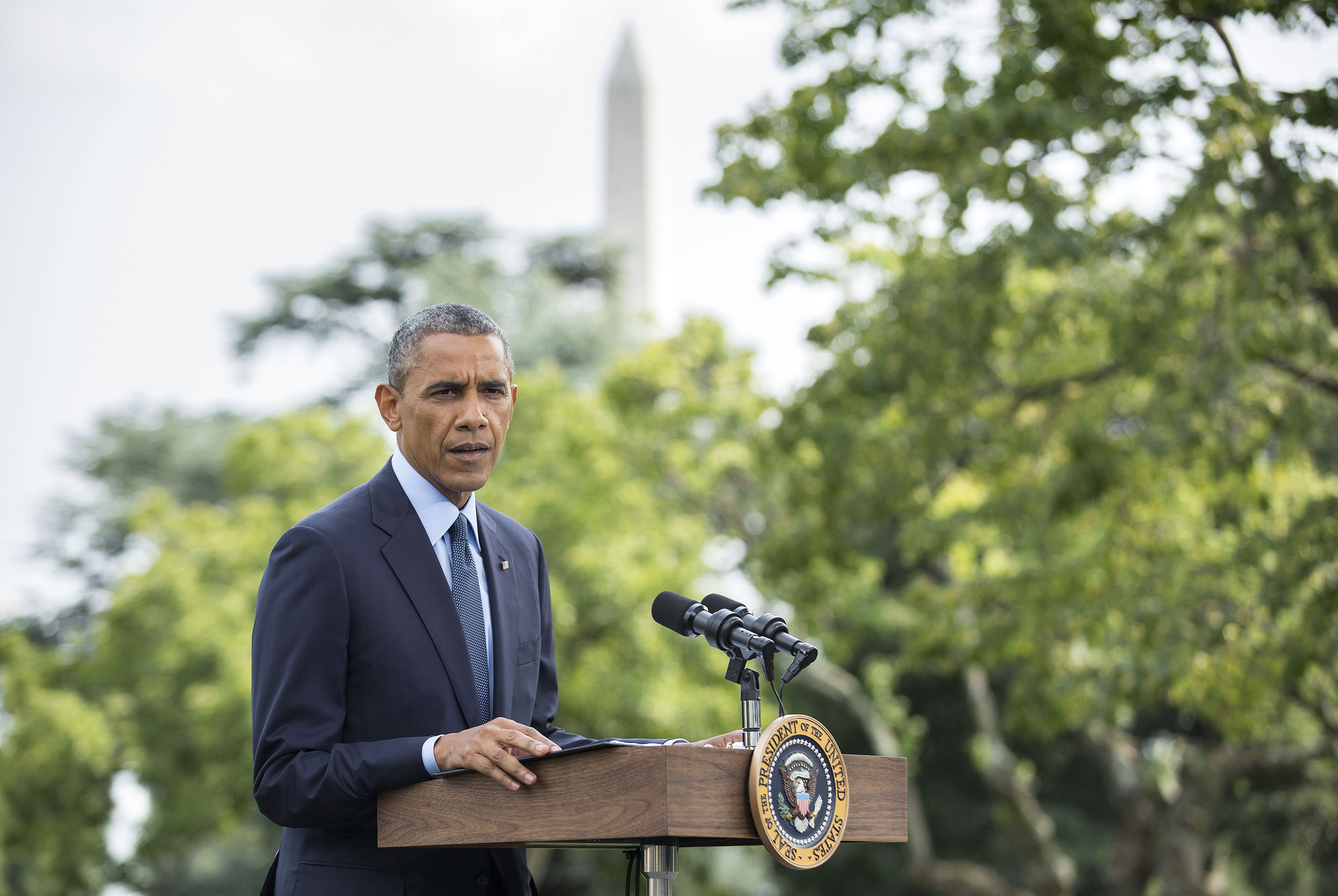 U.S. President Barack Obama speaks to reporters about new sanctions imposed on Russia as he departs the White House
