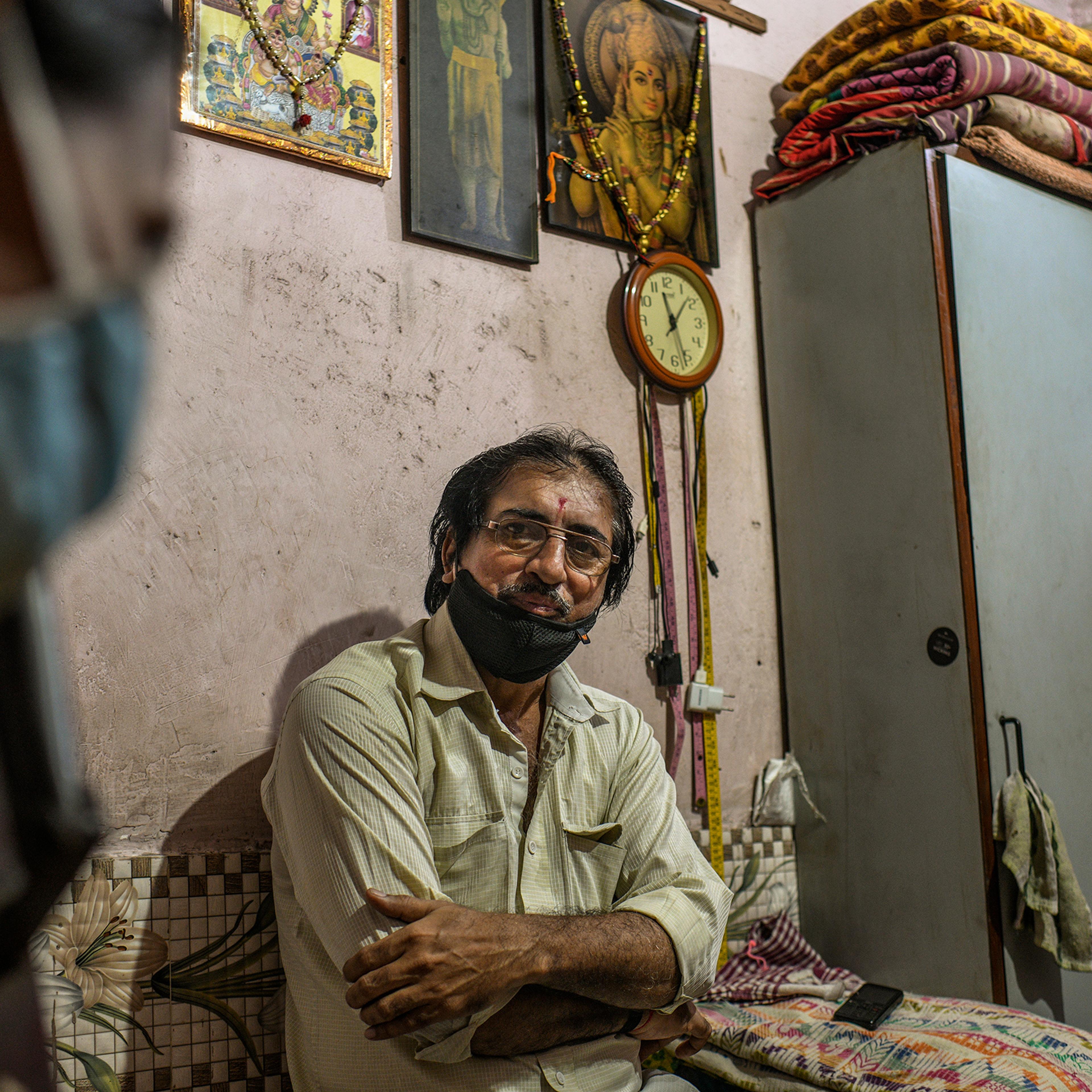 Jayanti Keshav Parmar, a tailor, at his home in Dharavi. His sewing machine sits idle, as no one in the neighborhood can afford to have new clothes stitched this year.