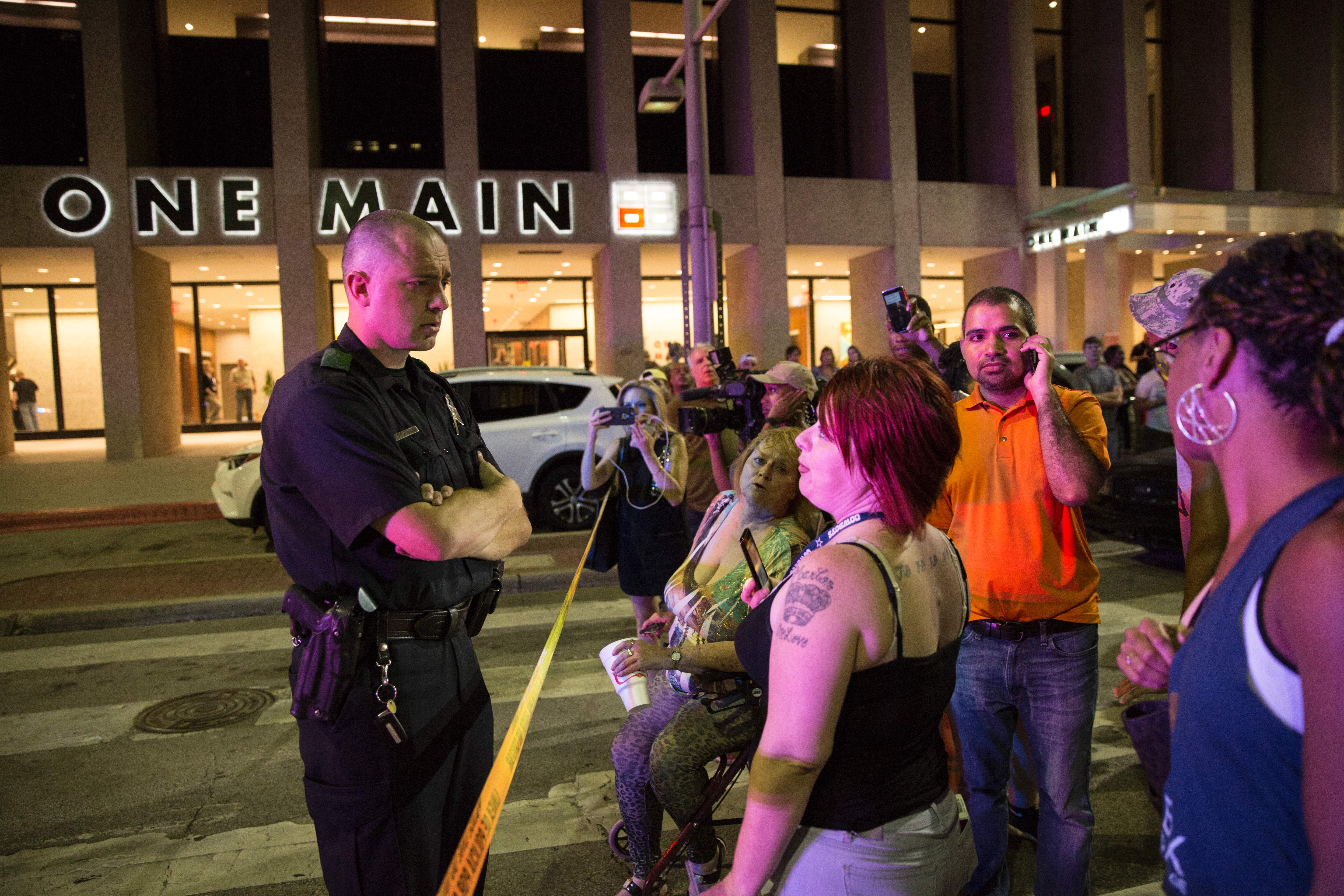 A police officer tries to calm protestors following the sniper shooting in Dallas on July 7, 2016.