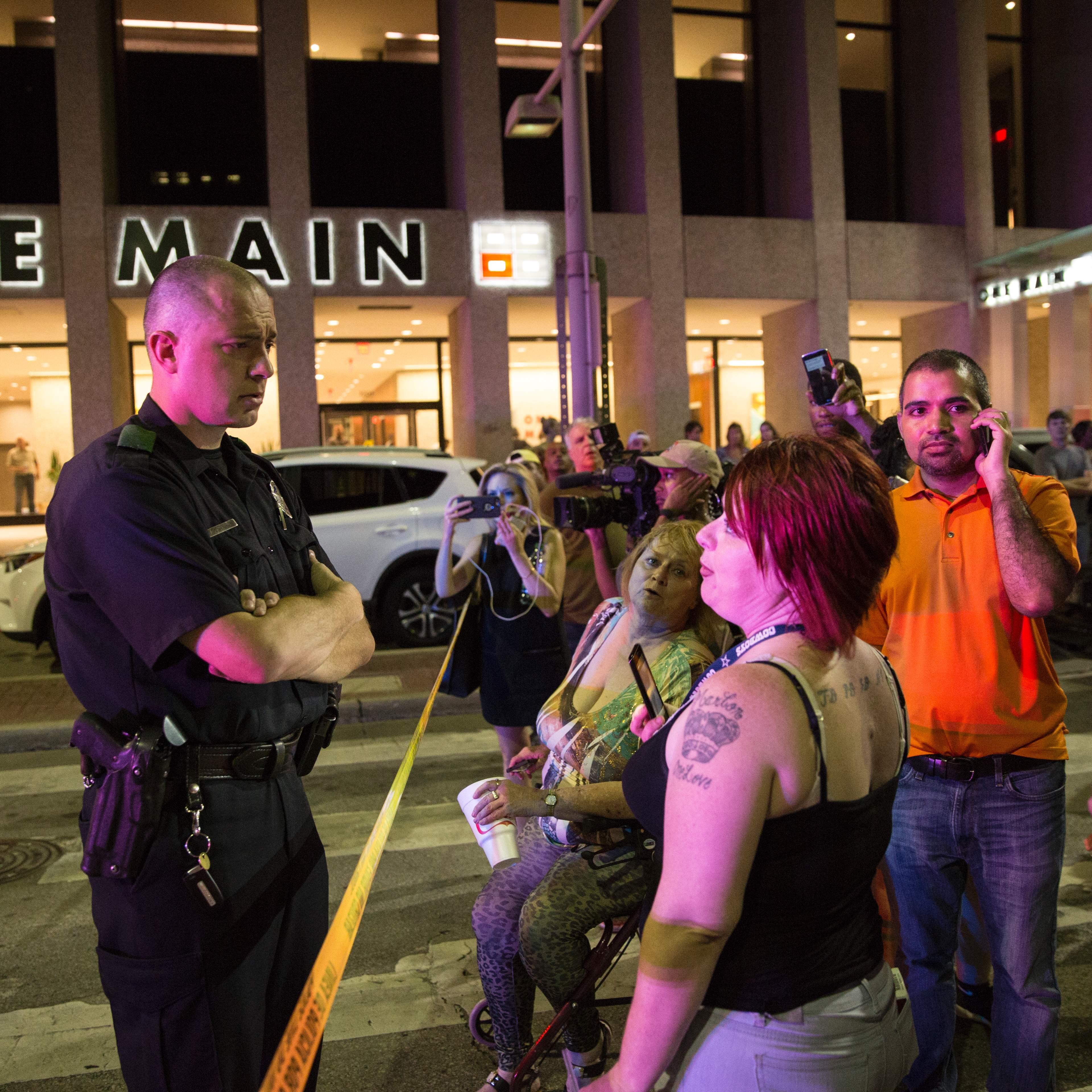 A police officer tries to calm protestors following the sniper shooting in Dallas on July 7, 2016.
