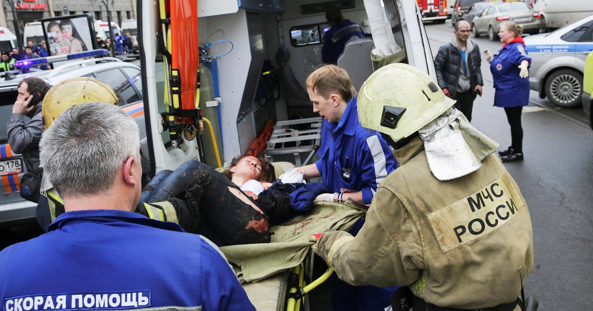 An injured person is helped by emergency services outside Sennaya Ploshchad metro station following explosions in St. Petersburg
