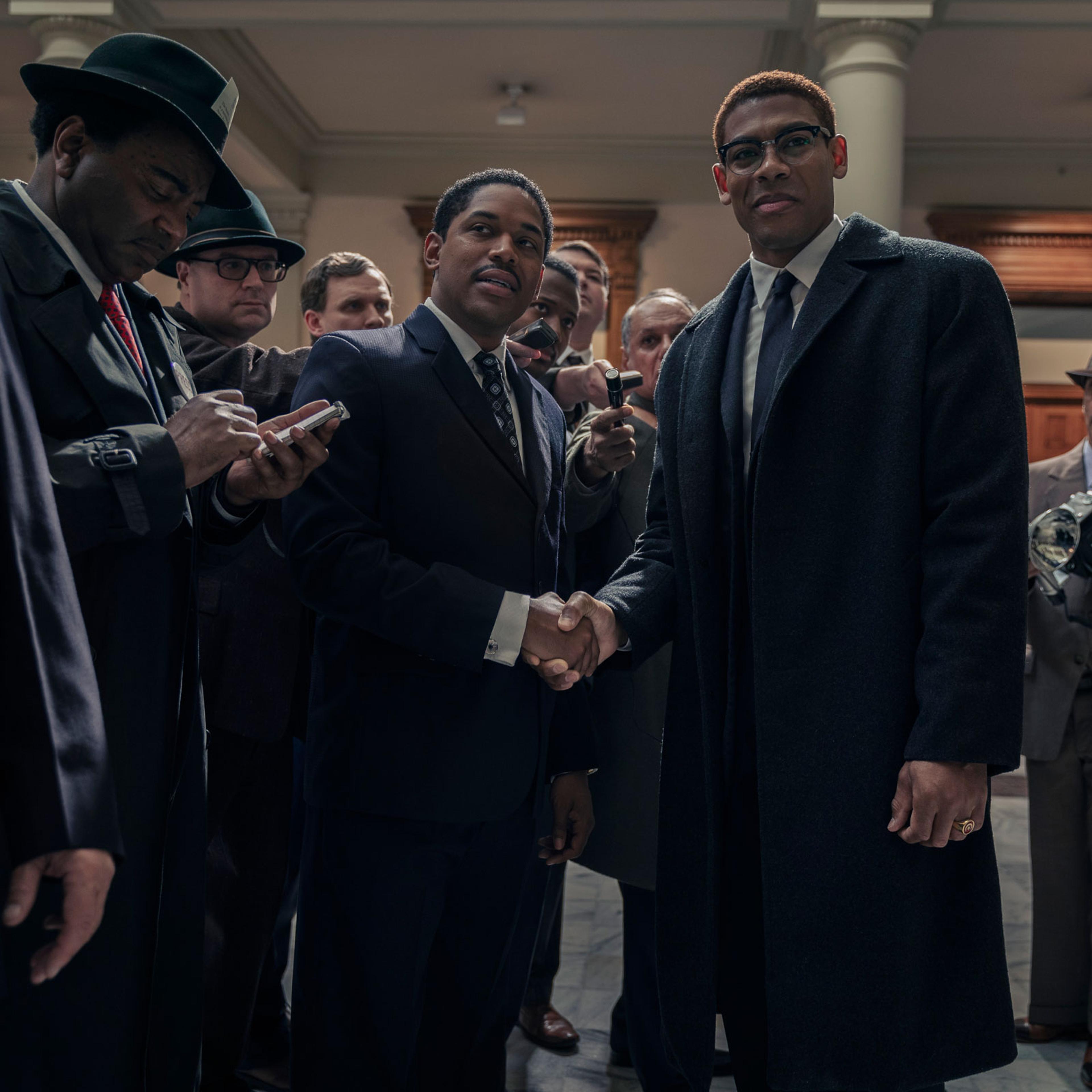 Martin Luther King Jr., played by Kelvin Harrison Jr., and Malcolm X, played by Aaron Pierre, are surrounded by reporters in the US Senate as seen in Genius: MLK/X.