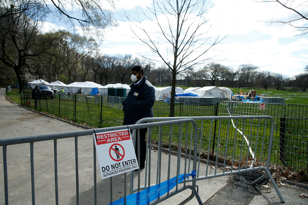 Security is posted at one of the access points to the temporary hospital built in Central Park on the East Meadow on April 2, 2020 in New York City.