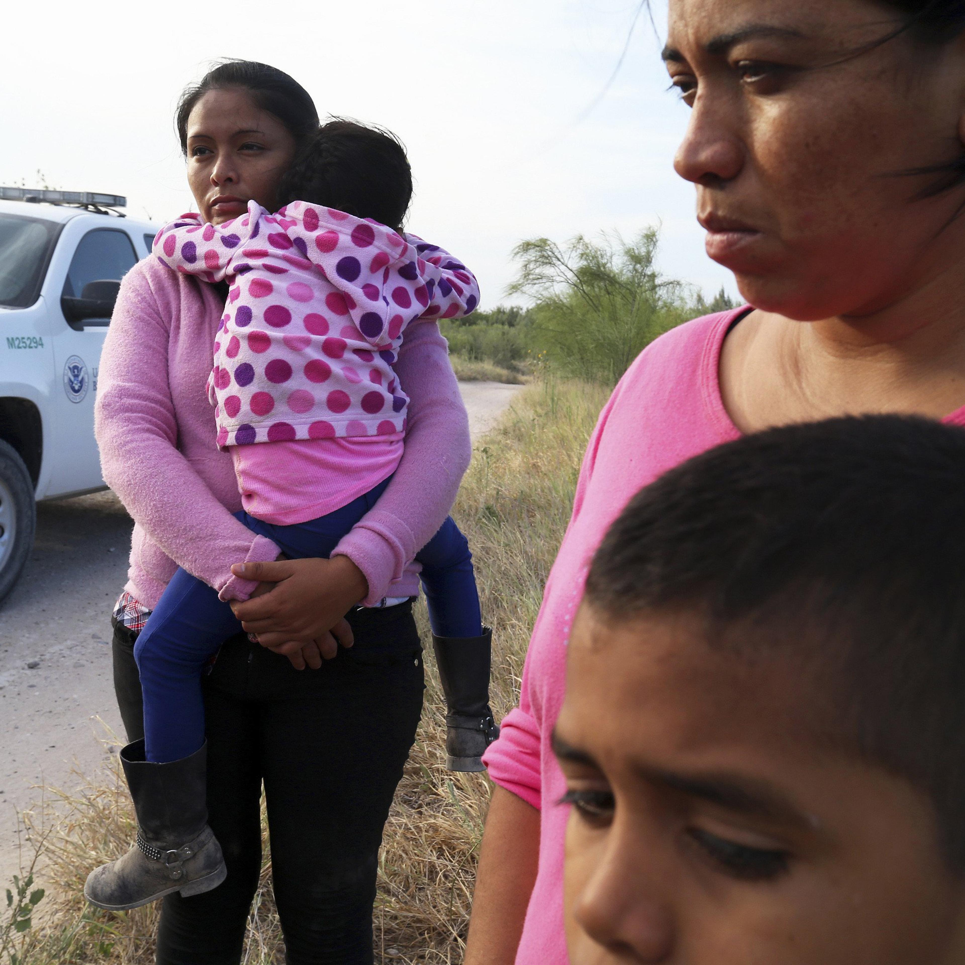 Border Patrol agents process a group of migrants from Honduras and Guatemala, mostly women and children, found walking near the Rio Grande near McAllen, Texas, June 18.