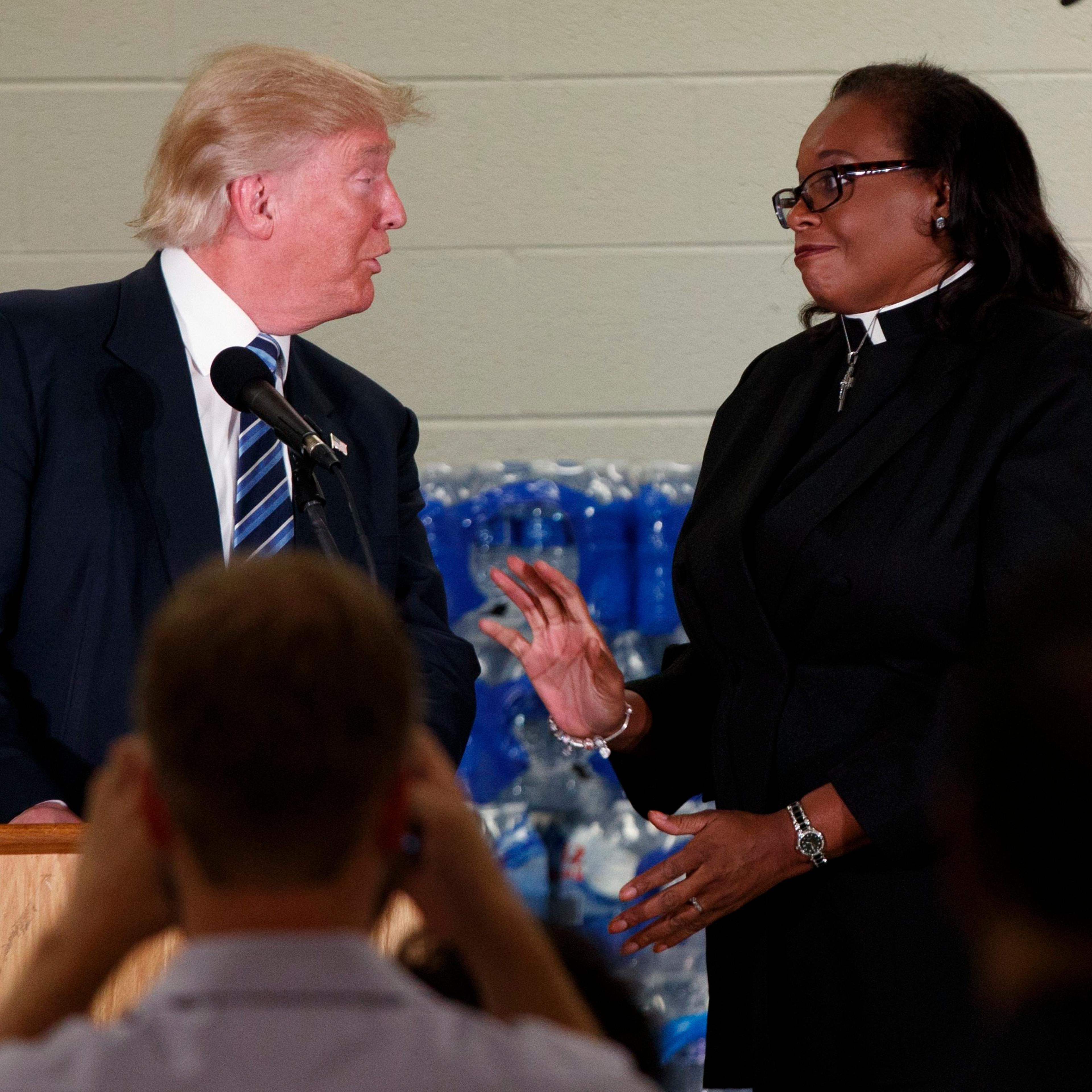 Rev. Faith Green Timmons interrupts Republican presidential candidate Donald Trump as he spoke during a visit to Bethel United Methodist Church, Sept. 14, 2016, in Flint, Mich.