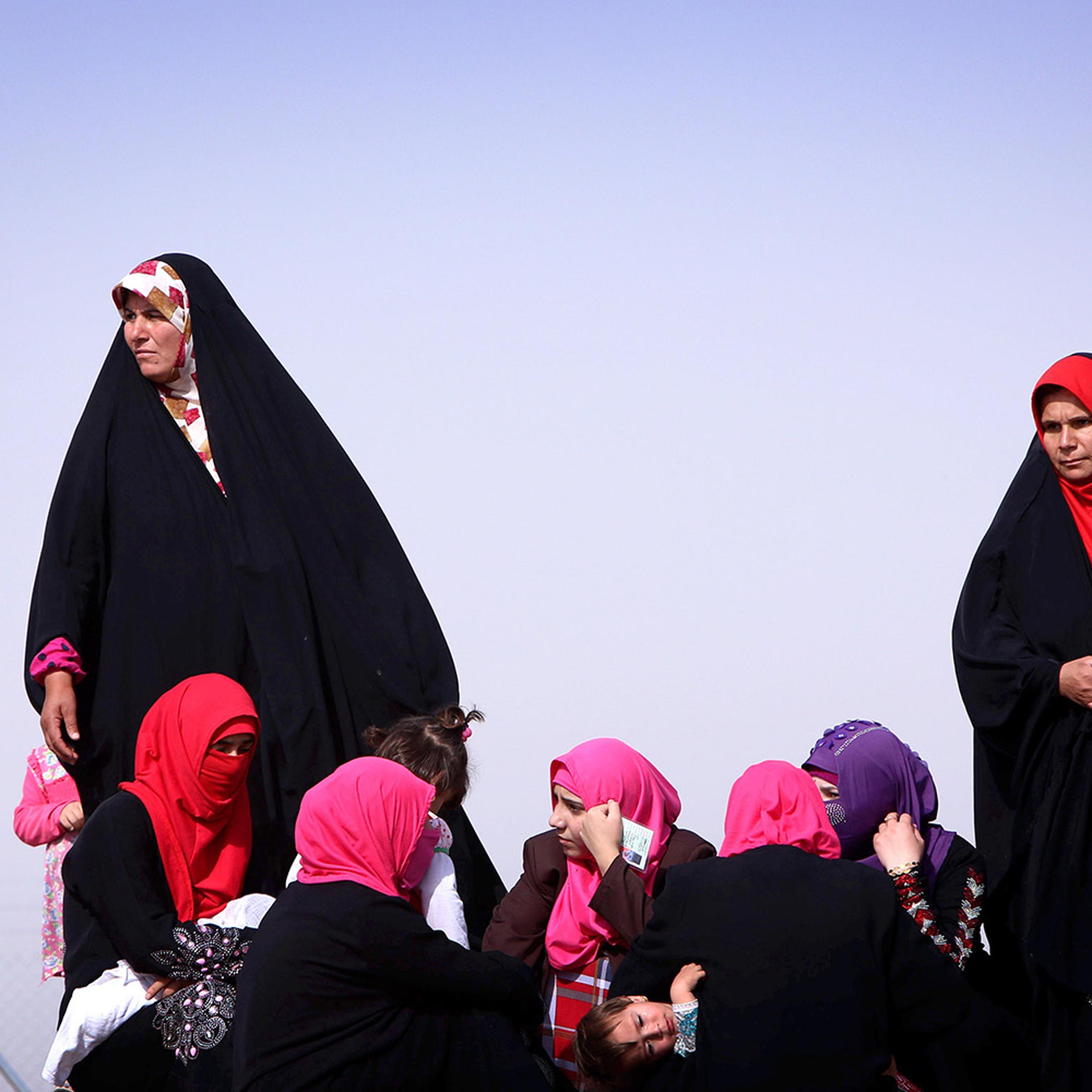 Iraqi women gather at a temporary camp set up to shelter civilians fleeing violence in northern Nineveh province in Aski Kalak, 25 miles west of Erbil, on June 13.