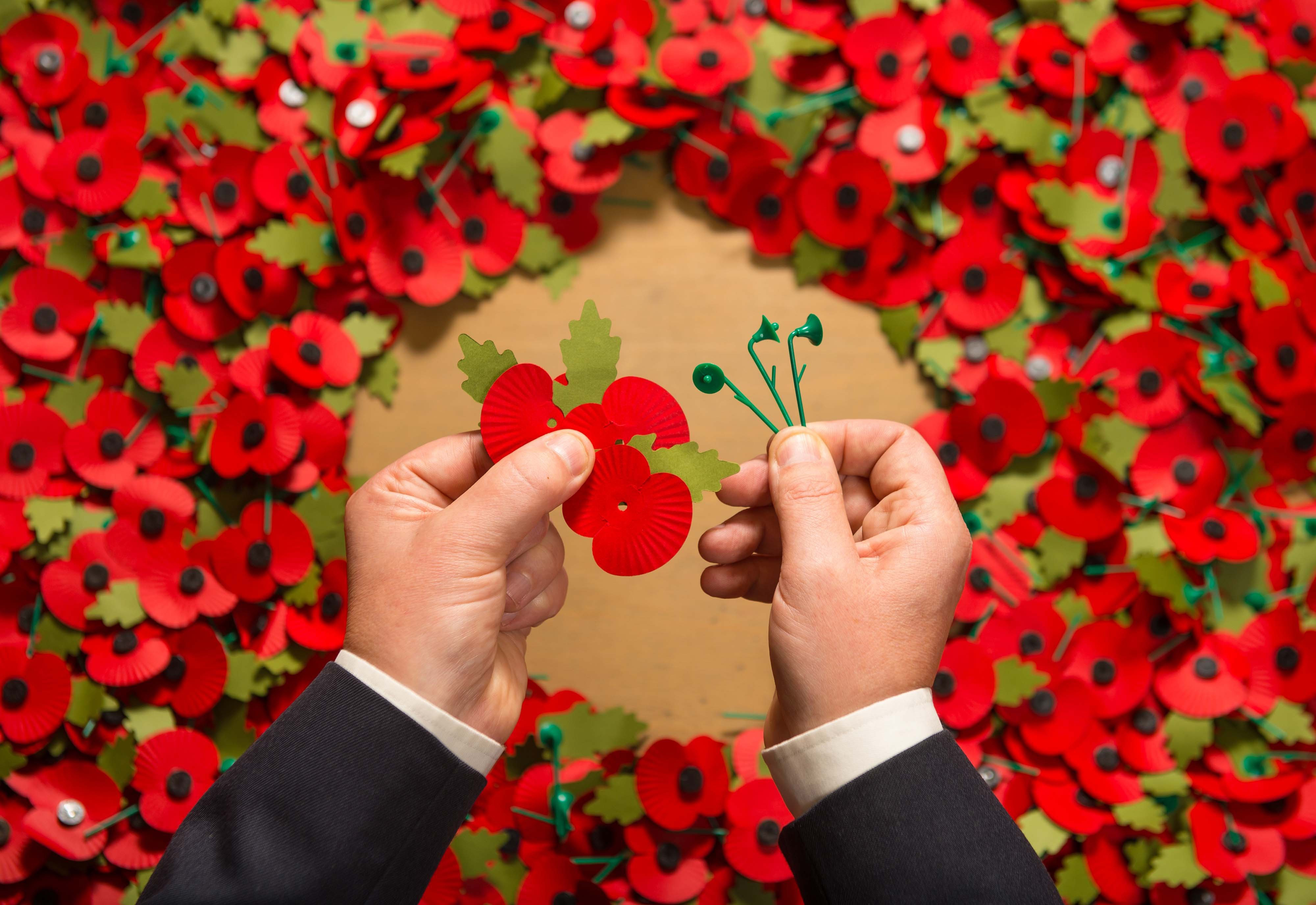Army veteran Shane Crowhurst pieces together a paper poppy at the Royal British Legion Poppy Appeal in Aylesford, Kent, which is one of the thousands of paper poppies that will be recycled through Sainsbury's after Armistice Day this year.