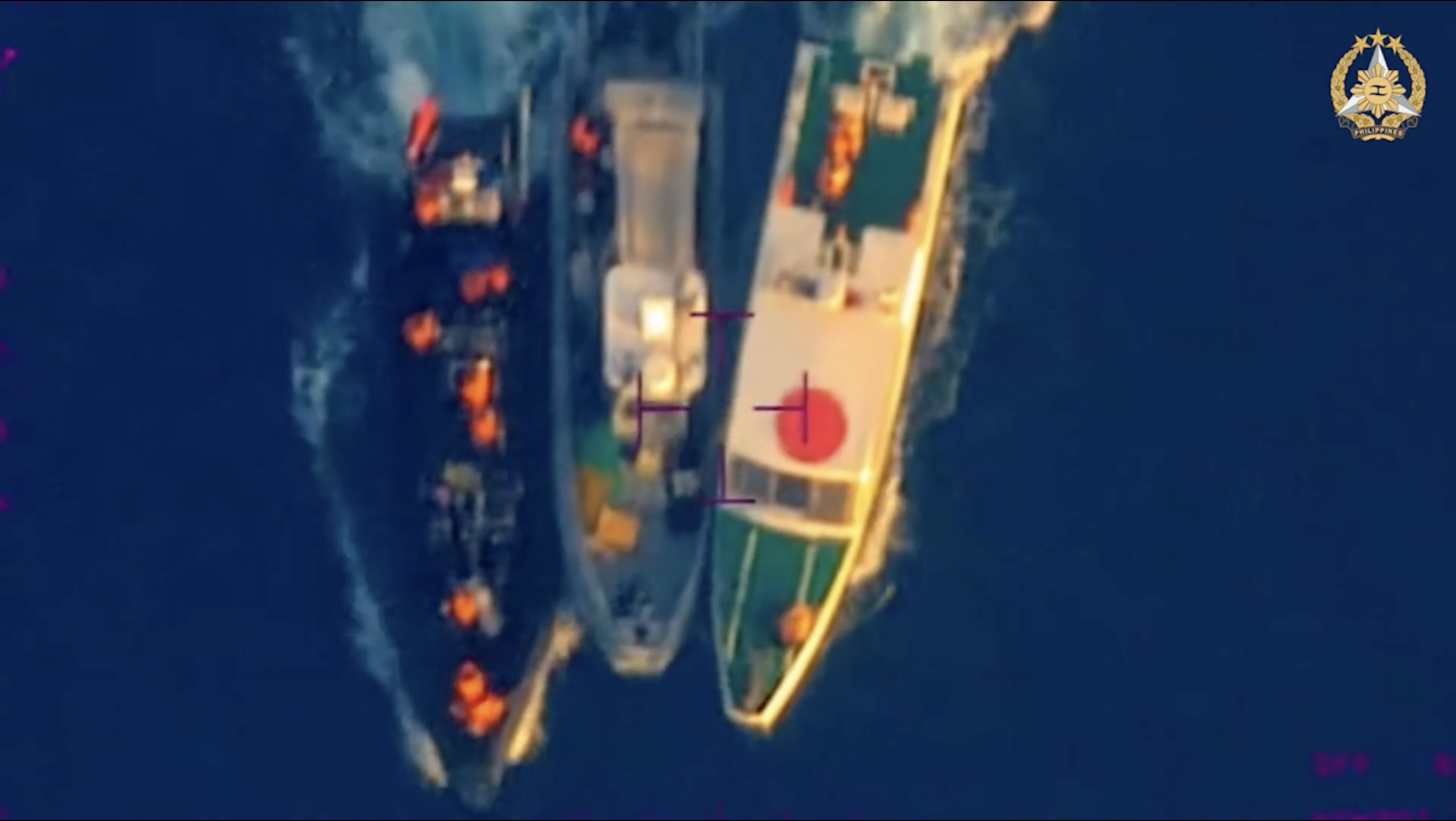 A screenshot from video provided by the Armed Forces of the Philippines purports to show a Philippine boat forcibly towed away from its fellow Philippine boats and troops by two China Coast Guard boats, in the South China Sea on June 17, 2024.