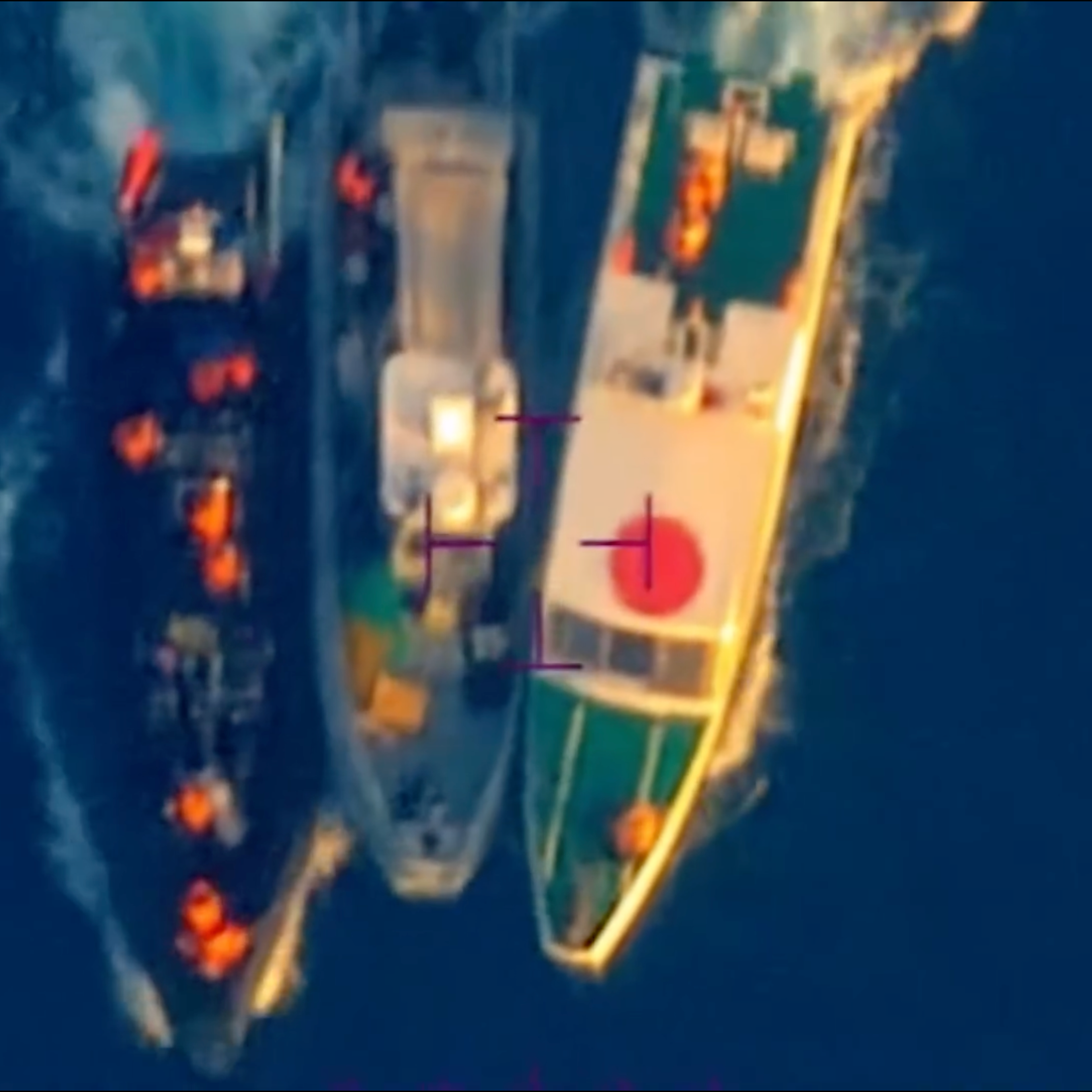 A screenshot from video provided by the Armed Forces of the Philippines purports to show a Philippine boat forcibly towed away from its fellow Philippine boats and troops by two China Coast Guard boats, in the South China Sea on June 17, 2024.