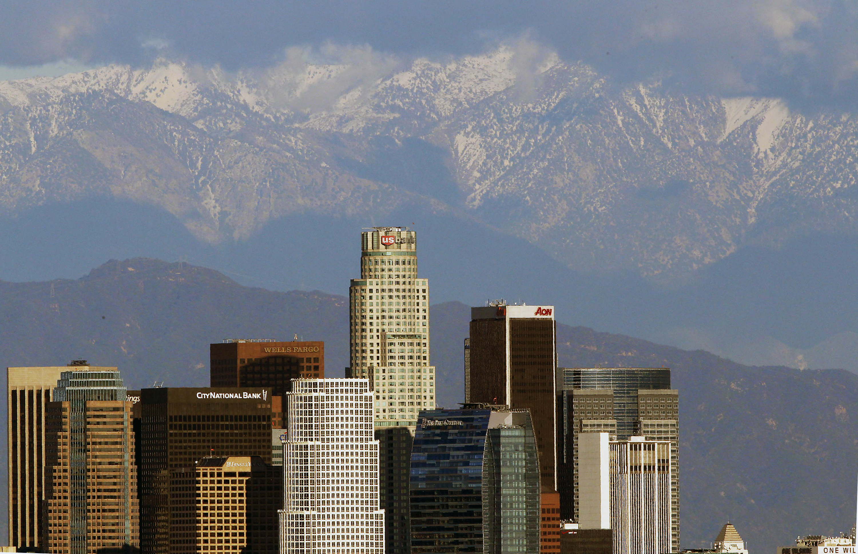 Snow covered San Gabriel Mountains rise behind the downtown Los Angeles skyline on Dec. 27, 2012.