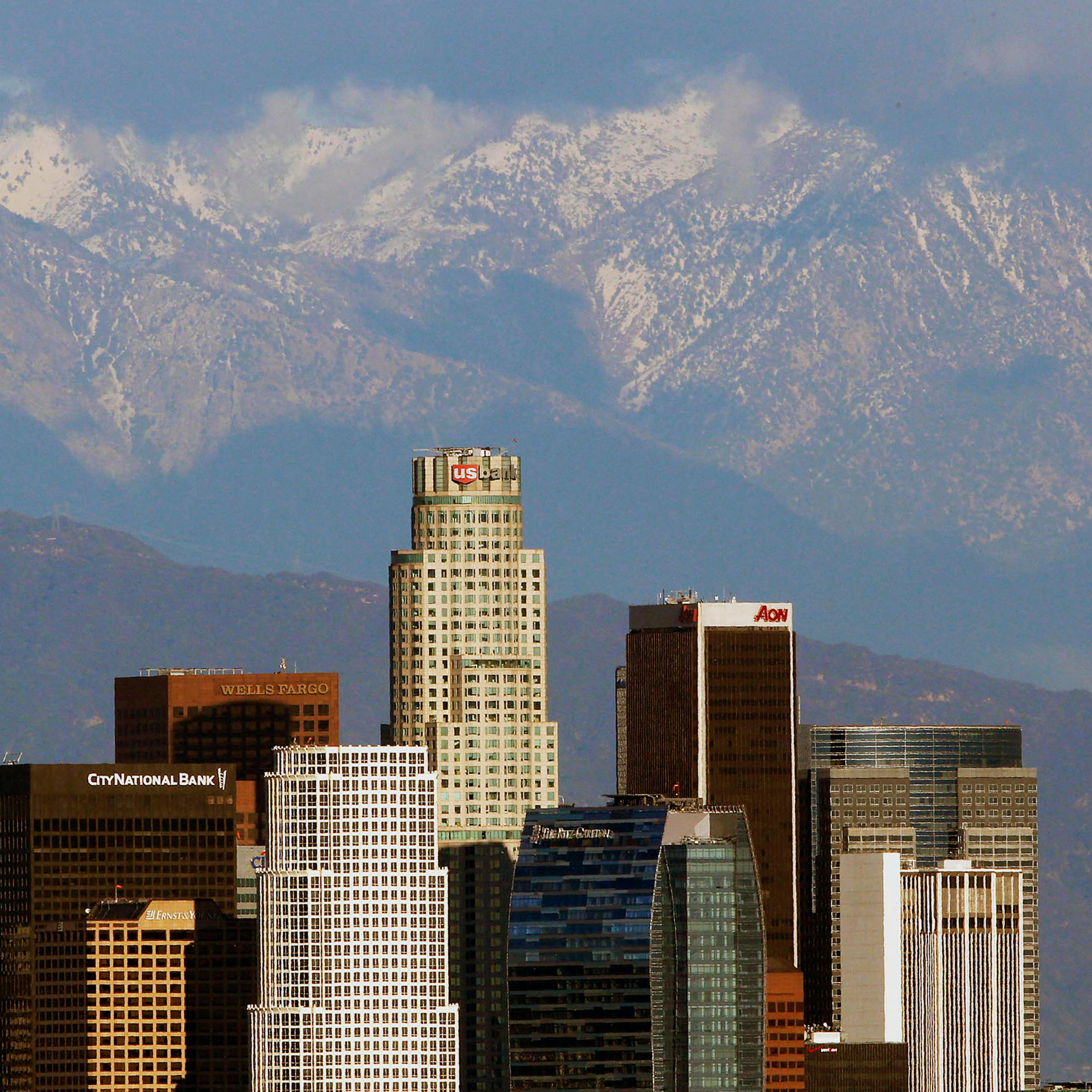 Snow covered San Gabriel Mountains rise behind the downtown Los Angeles skyline on Dec. 27, 2012.