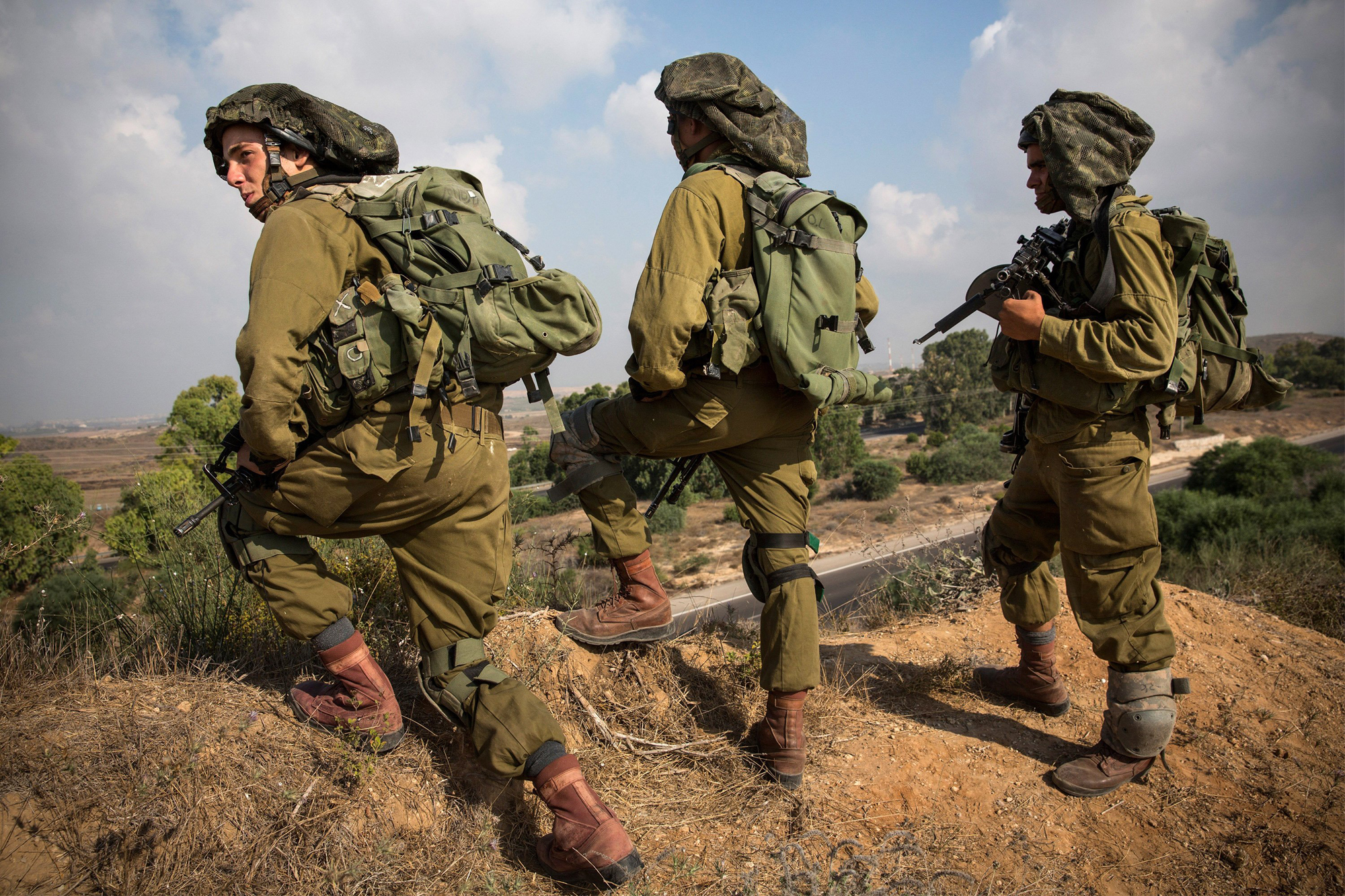 Israeli soldiers position themselves on a hill overlooking the Israeli-Gaza border during operation "Protective Edge" on July 21, 2014 near Sderot, Israel.