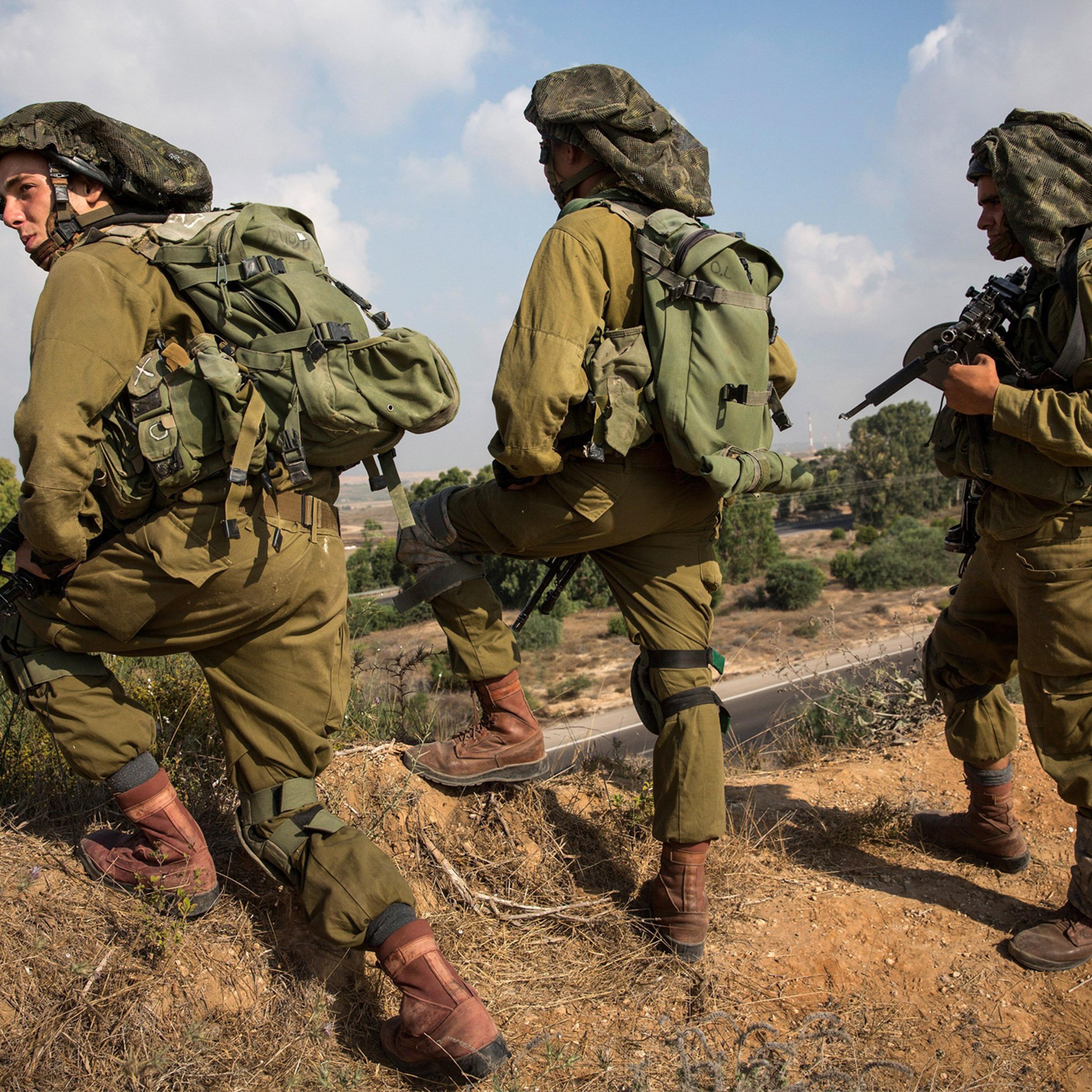 Israeli soldiers position themselves on a hill overlooking the Israeli-Gaza border during operation "Protective Edge" on July 21, 2014 near Sderot, Israel.