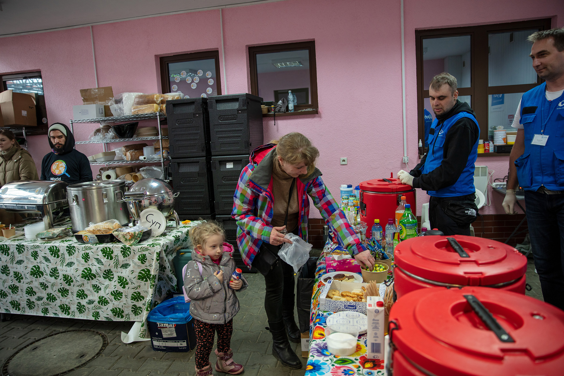 PAH volunteers assist Natalia Kzakova and her daughter, Sofia, who fled the fighting in their home of Mariupol, in Hrebrenne, Poland, on April 11, 2022.