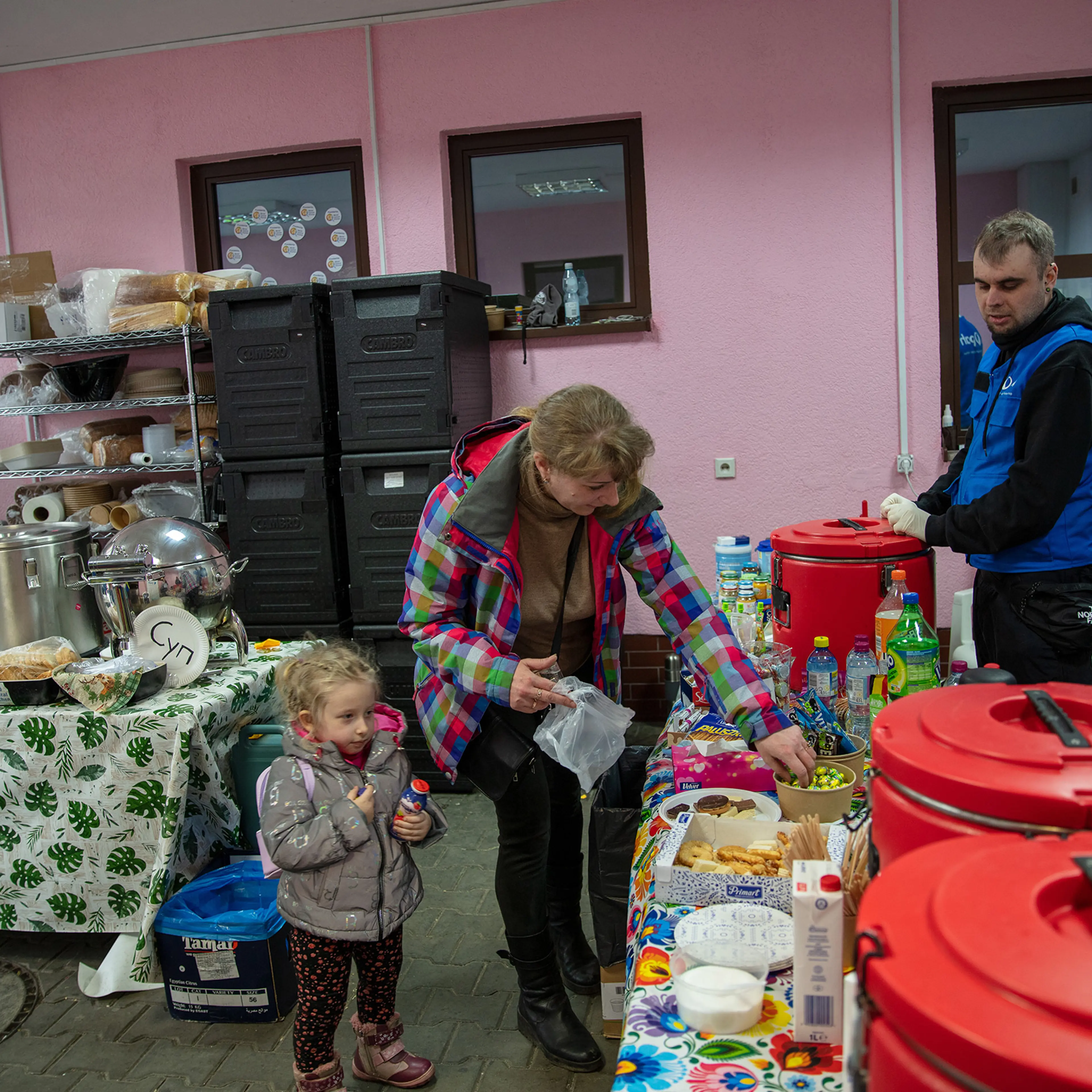 PAH volunteers assist Natalia Kzakova and her daughter, Sofia, who fled the fighting in their home of Mariupol, in Hrebrenne, Poland, on April 11, 2022.