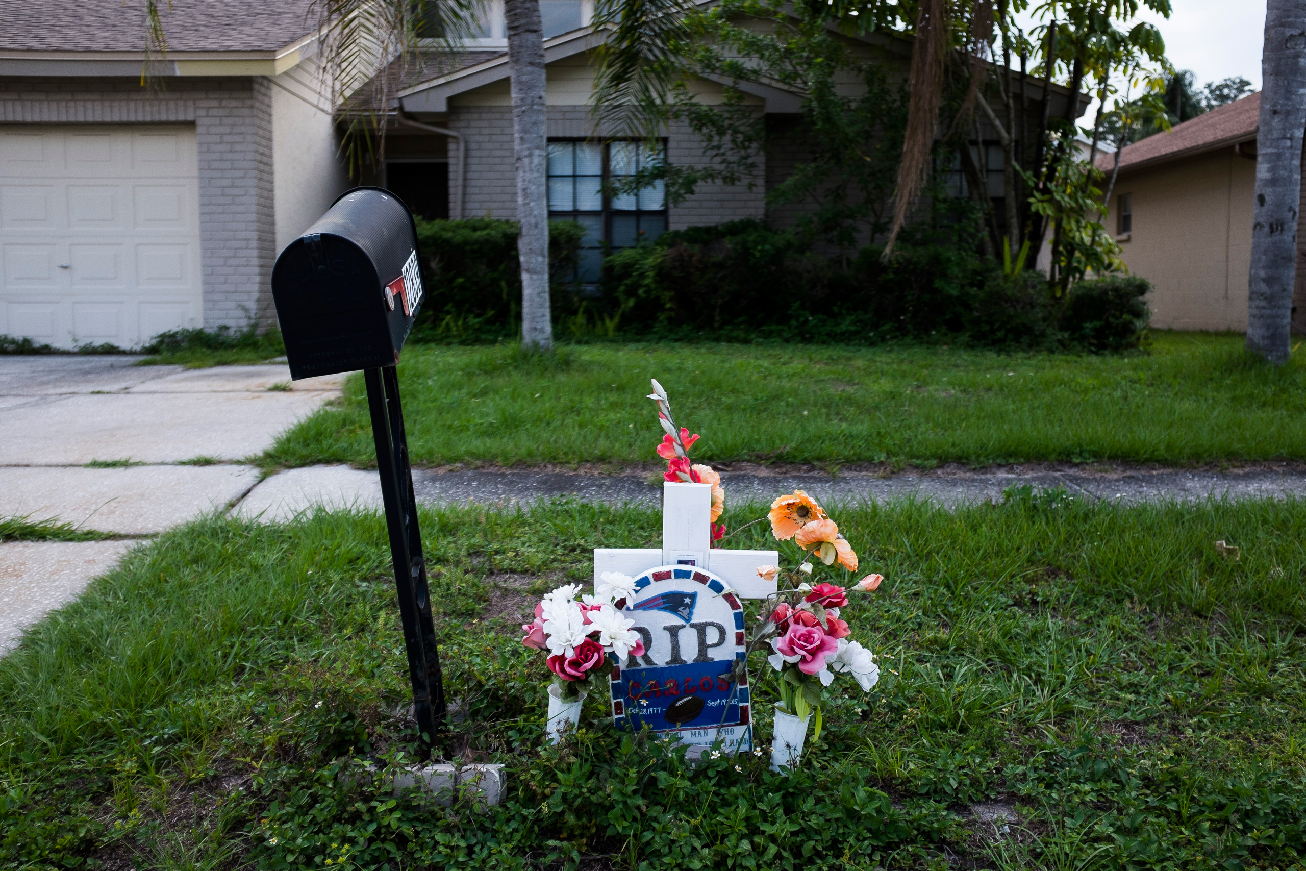 This Sept. 15, 2016 photo shows a memorial for Carlos Garica which has sat outside Yaileen Ayala's home for the last year. It marks where her ex-husband died after he was shot following an argument with a neighbor. (Zack Wittman/The Tampa Bay Times via A