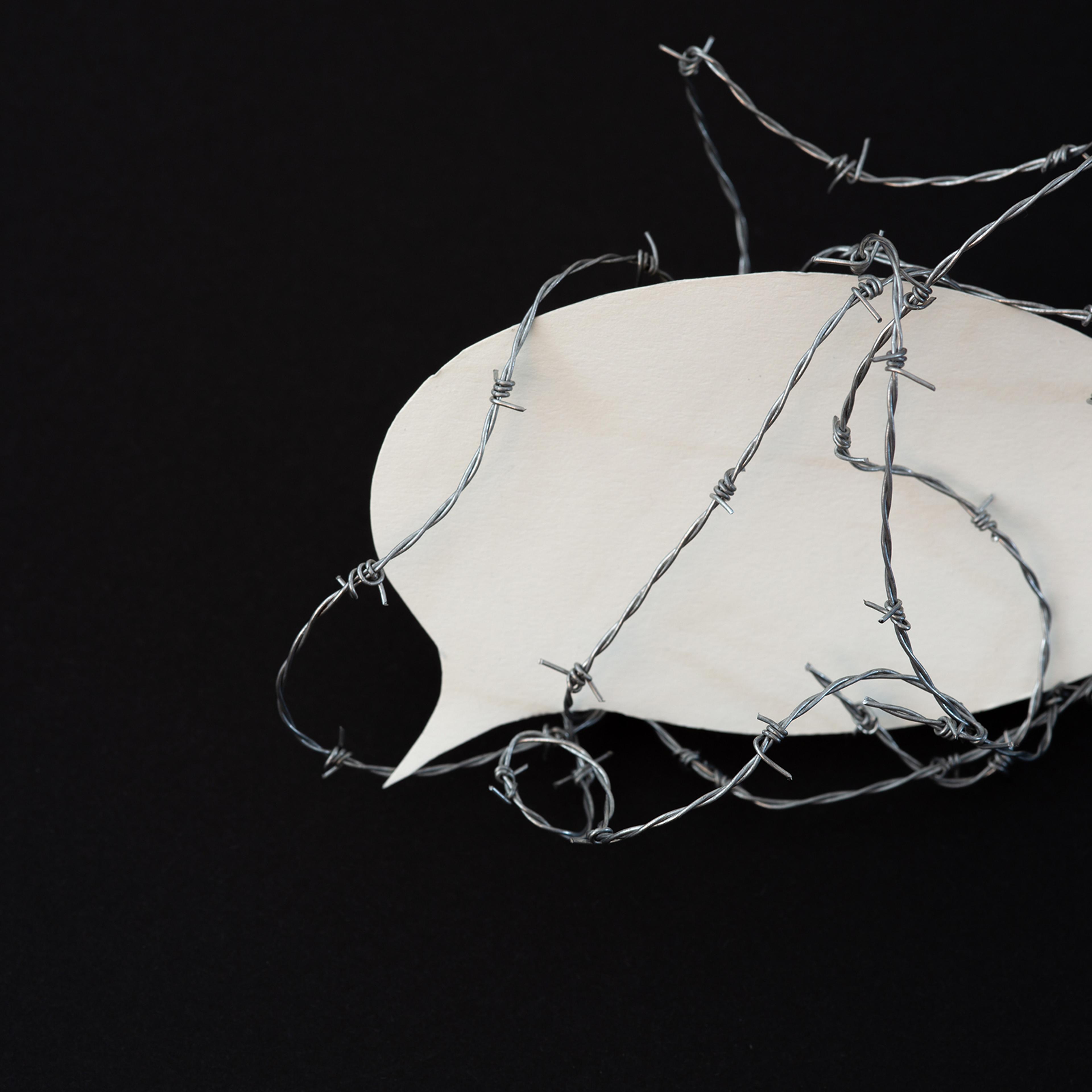 Protect the freedom of speech - barbed wire around a speech bubble