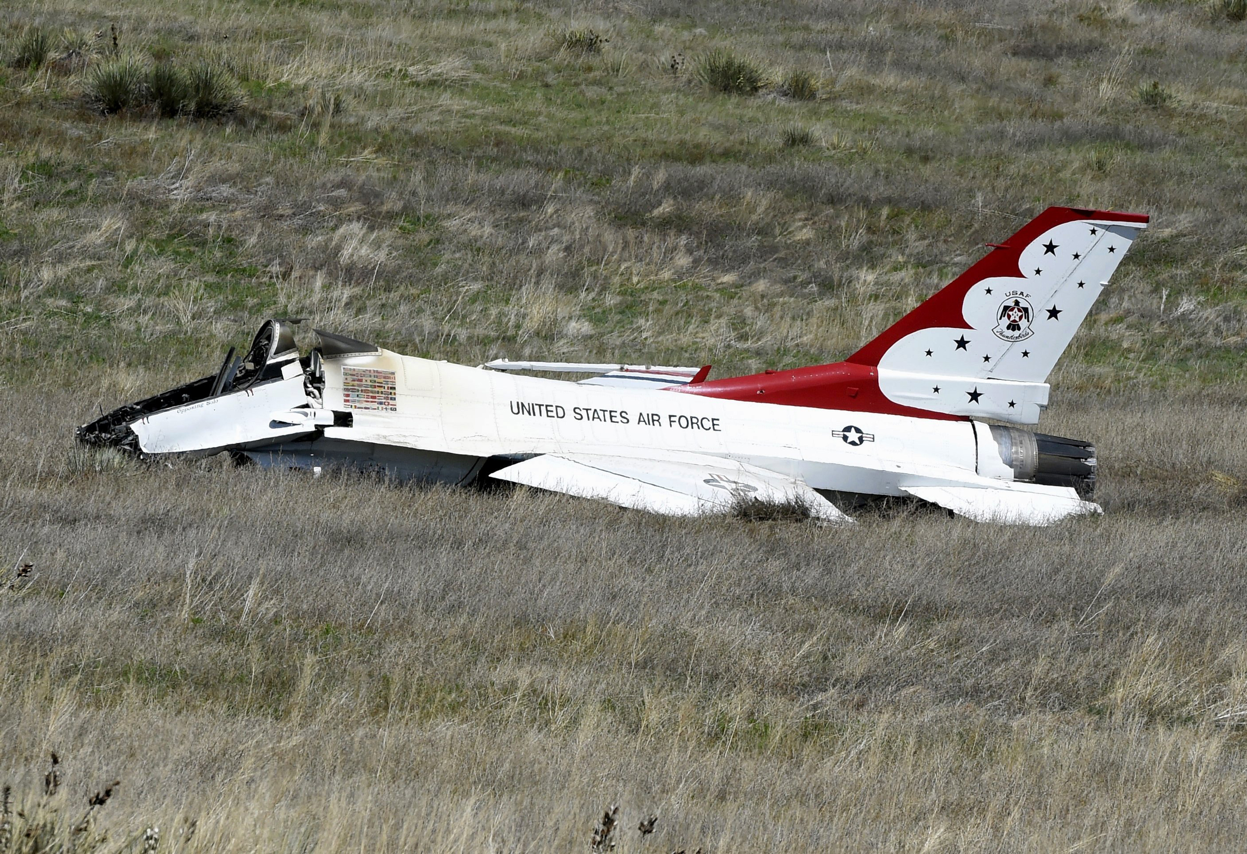 A U.S. Air Force Thunderbird that crashed following a flyover rests on the ground south of the Colorado Springs, Colo., airport after a performance at a commencement for Air Force Academy cadets Thursday, June 2, 2016. The pilot ejected safely from the j