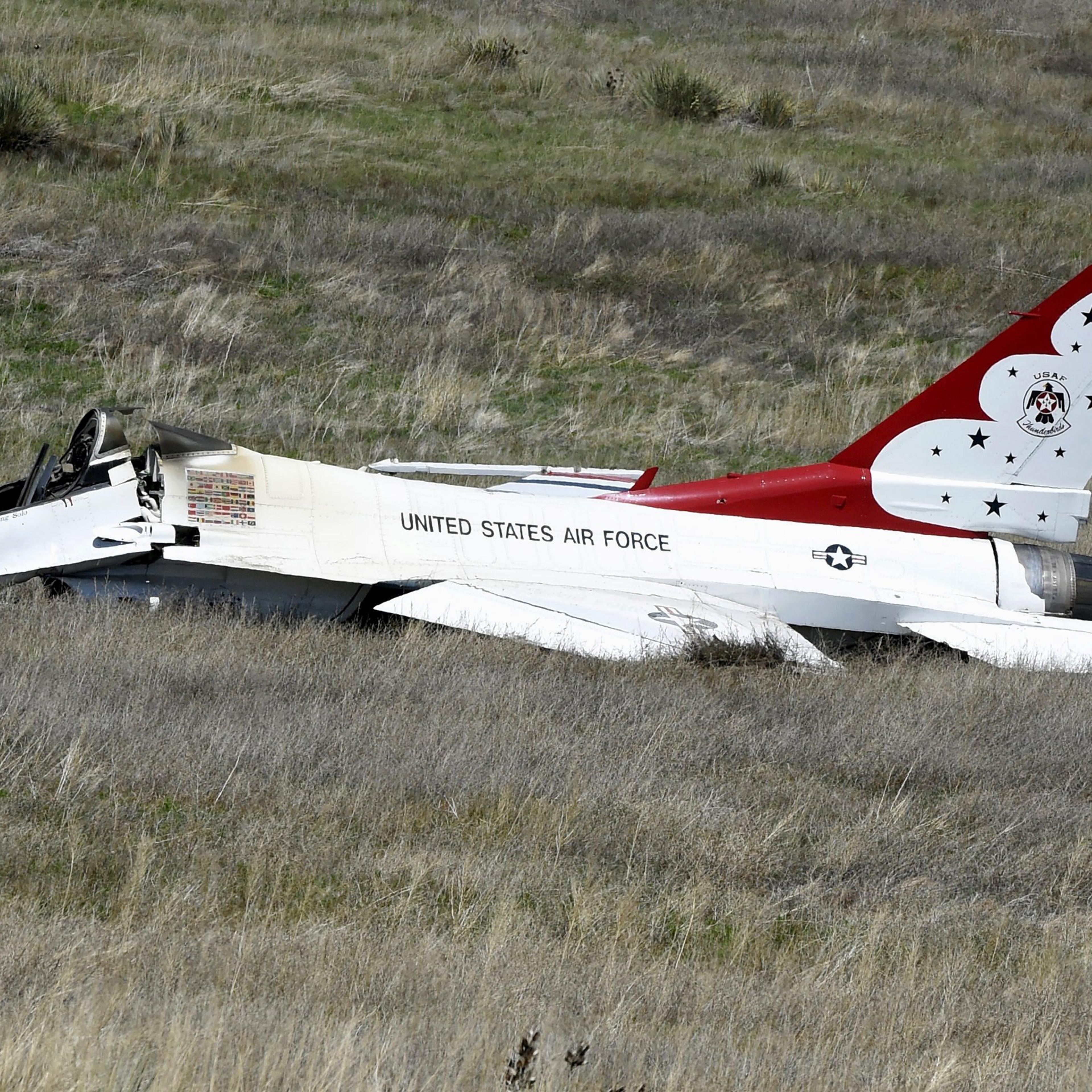 A U.S. Air Force Thunderbird that crashed following a flyover rests on the ground south of the Colorado Springs, Colo., airport after a performance at a commencement for Air Force Academy cadets Thursday, June 2, 2016. The pilot ejected safely from the j