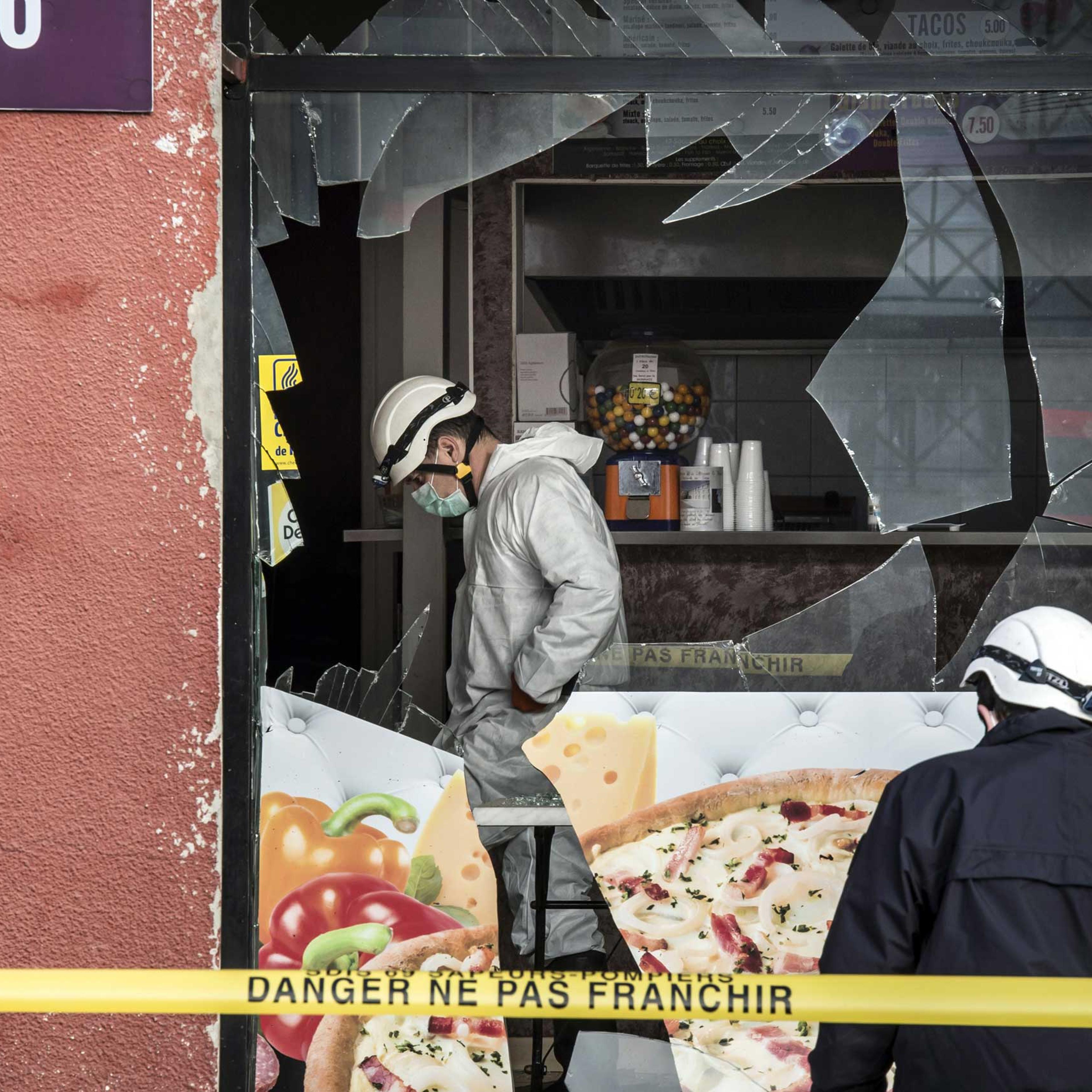 French police forensic scour the scene of an explosion at a kebab shop damaged following an explosion near a mosque, on Jan. 8, 2015, in Villefranche-sur-Saone, eastern France.