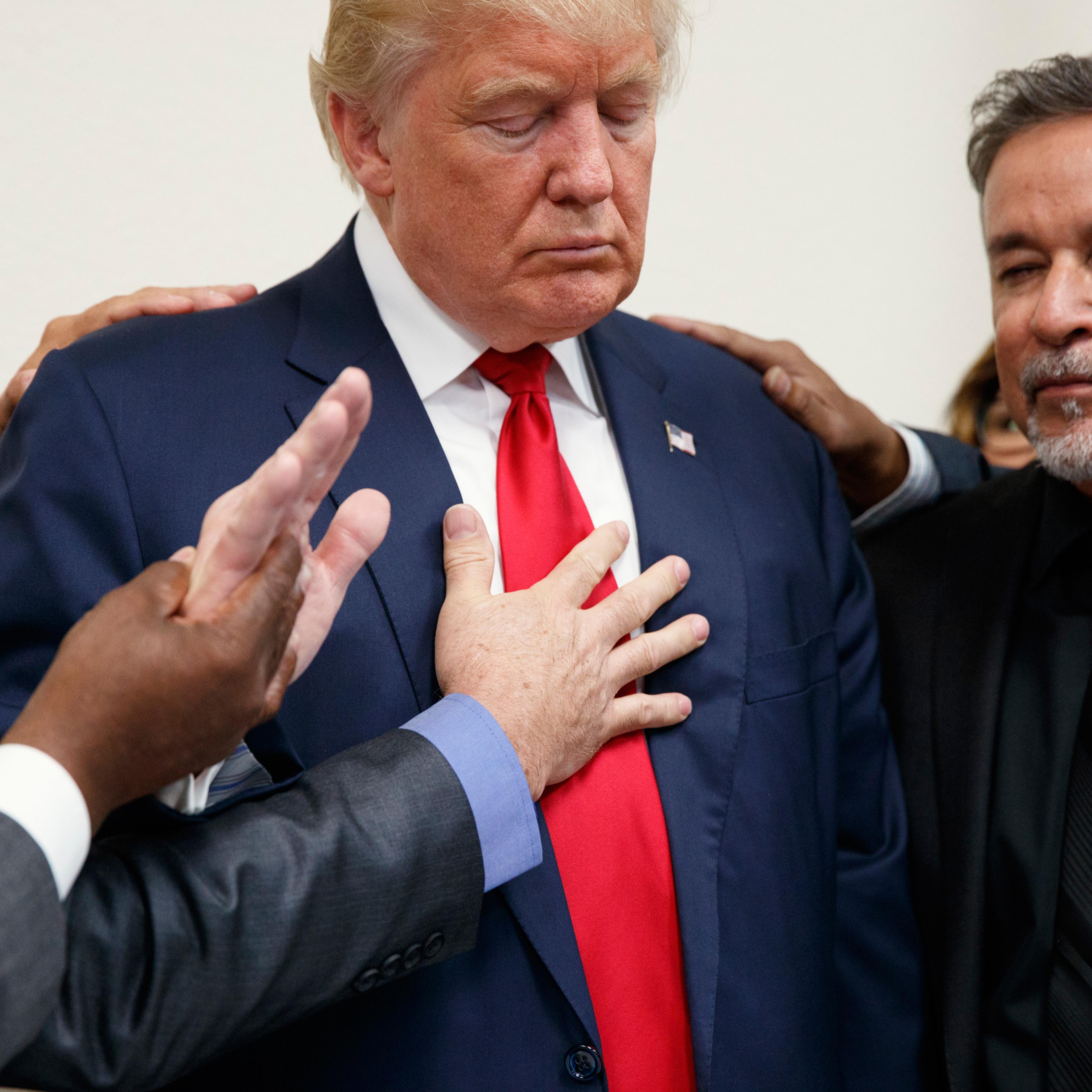 Pastors from the Las Vegas area pray with Republican presidential candidate Donald Trump during a visit to the International Church of Las Vegas, and International Christian Academy, Wednesday, Oct. 5, 2016, in Las Vegas. (AP Photo/ Evan Vucci)
