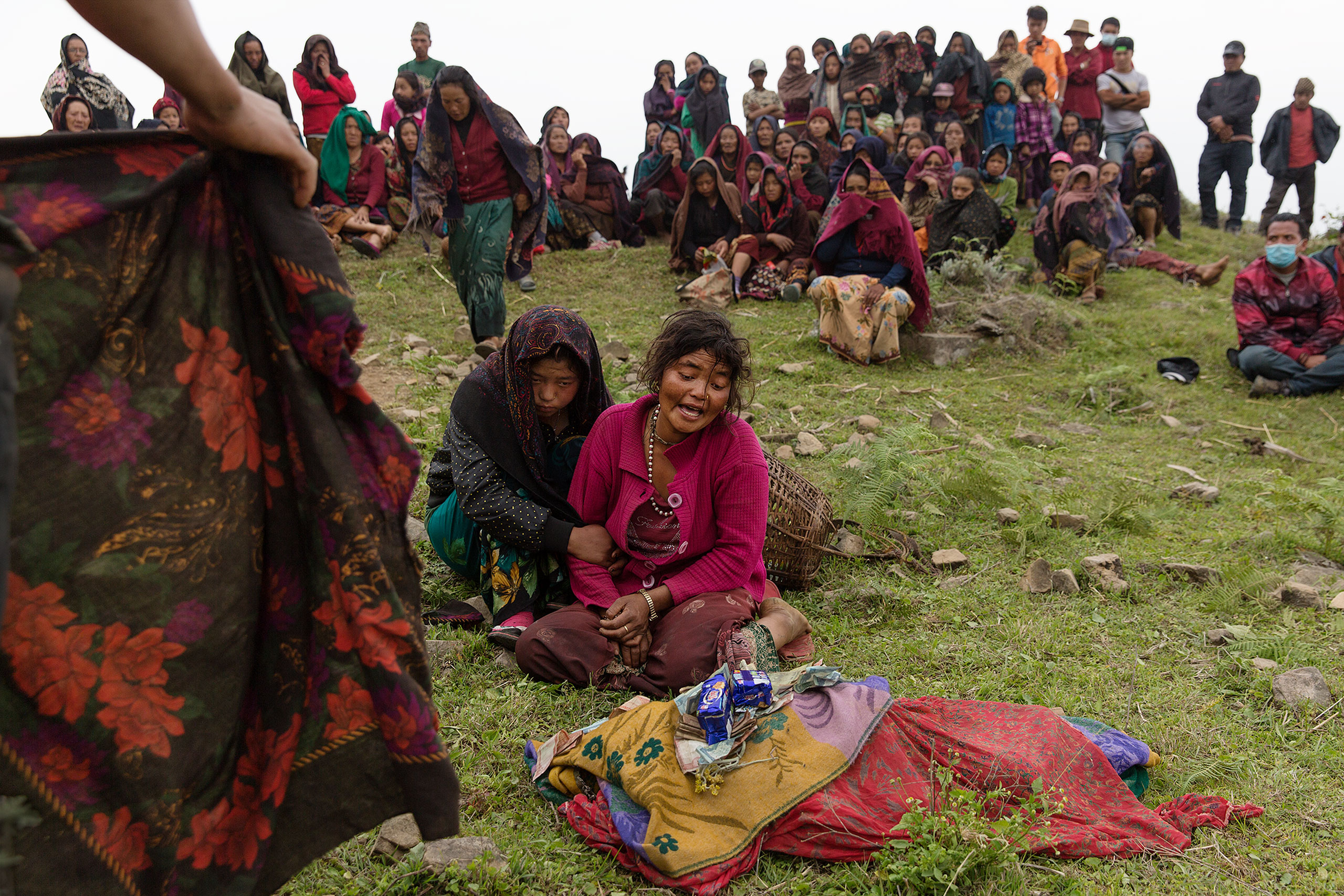Nepal earthquake. Gumda Village, in Ghorka district. 5 people died and 14 are still missing in landslides. Inhabitants salvaging building materials from their destroyed houses. Funeral of Rejina Gurung, 3 who was just discovered buried in the rubble. Her