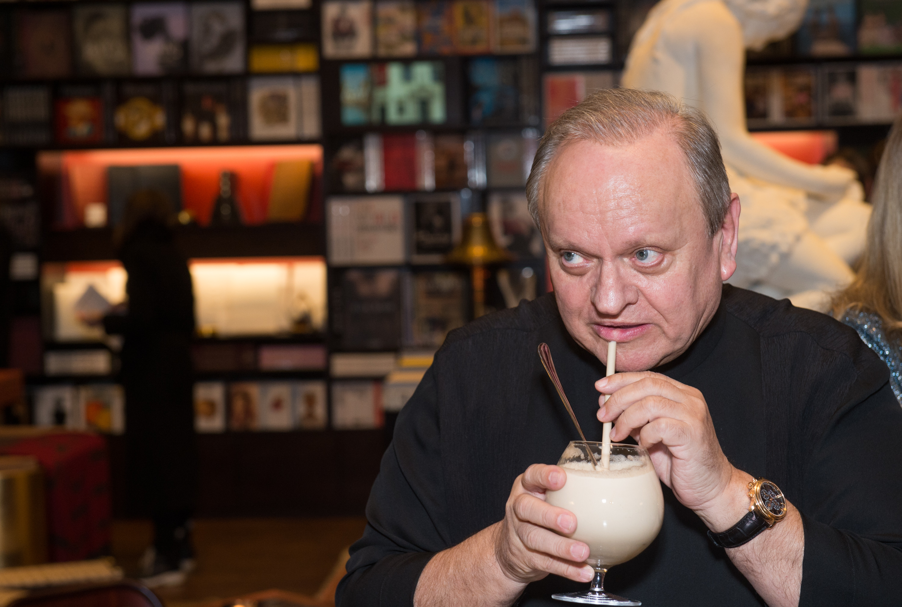 Chef Joel Robuchon sips a drink at book party