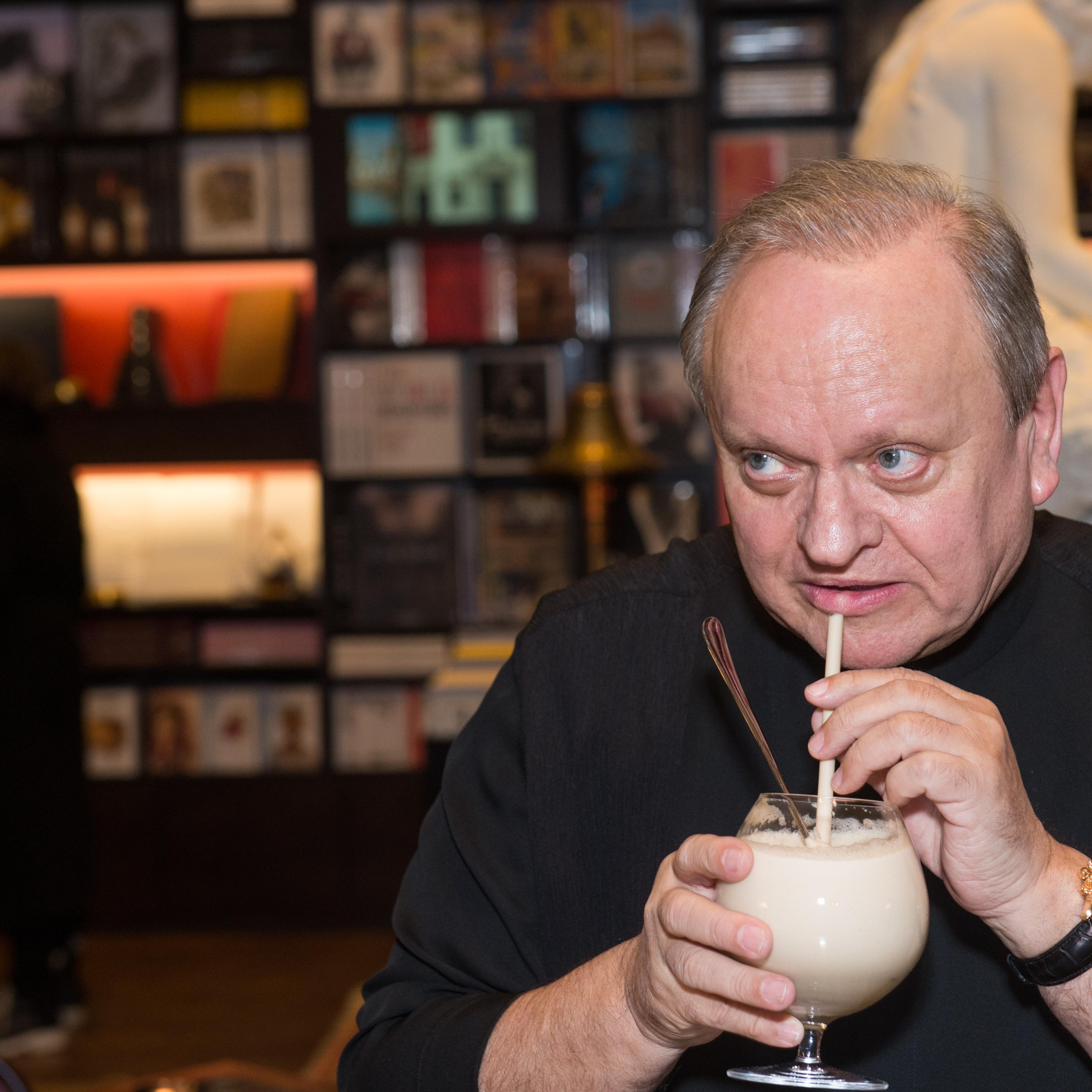 Chef Joel Robuchon sips a drink at book party