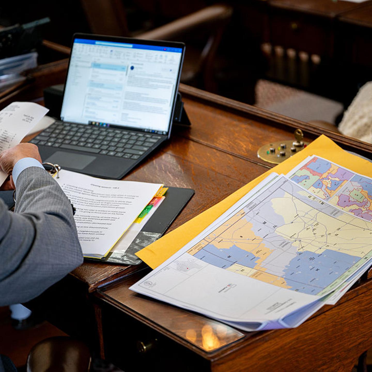 Maps are displayed on Texas Democratic Rep. Chris Turner's desk during a House meeting in the State Capitol in Austin, Texas on Aug. 20, 2025.