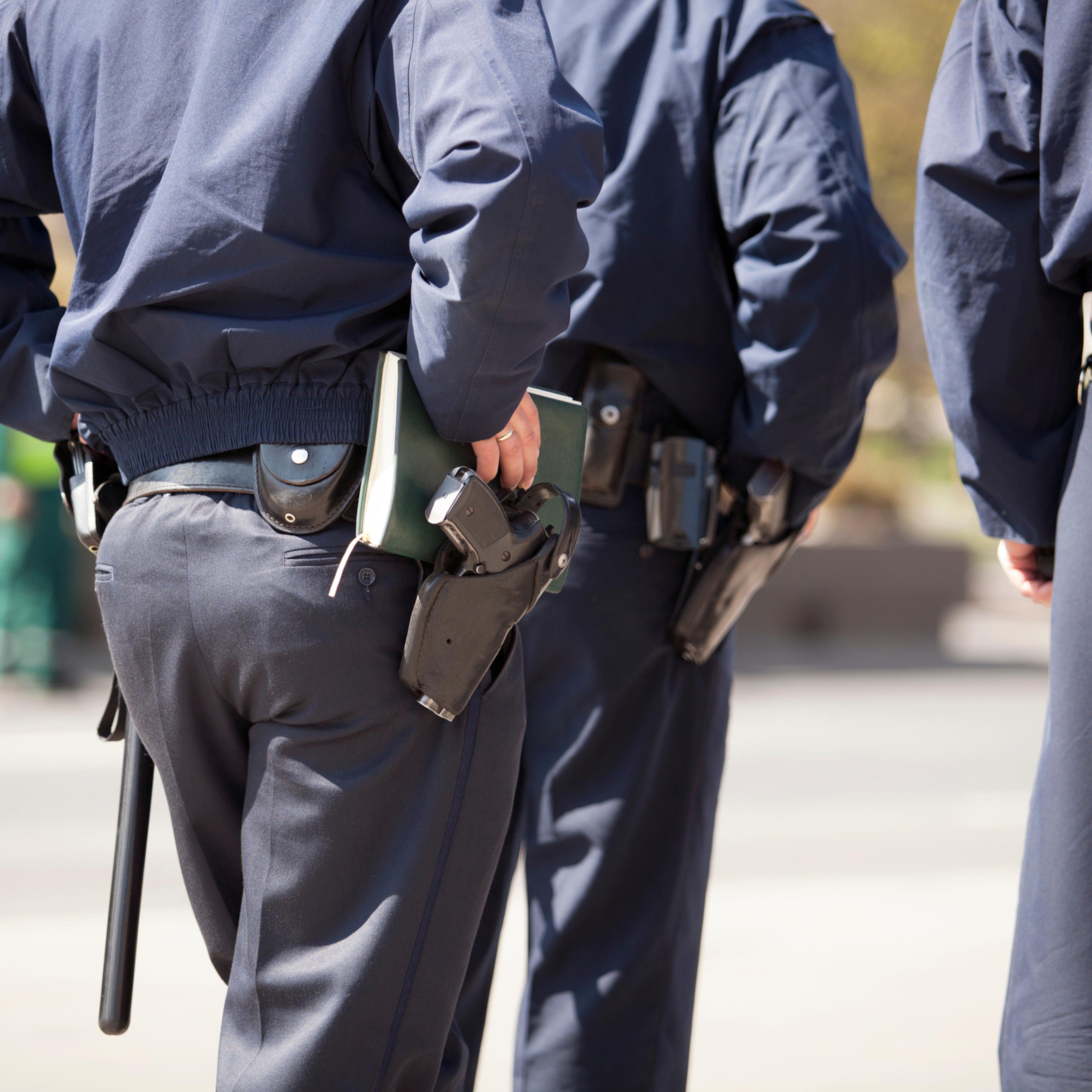 Rear Midsection Of Police Force On Street