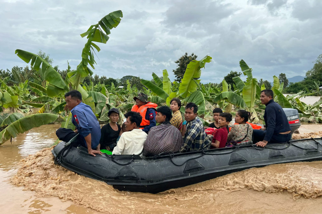 Residents are transported on a boat through flood waters in Sin Thay village in Pyinmana, in Myanmar's Naypyidaw region, on Sept. 13, 2024.