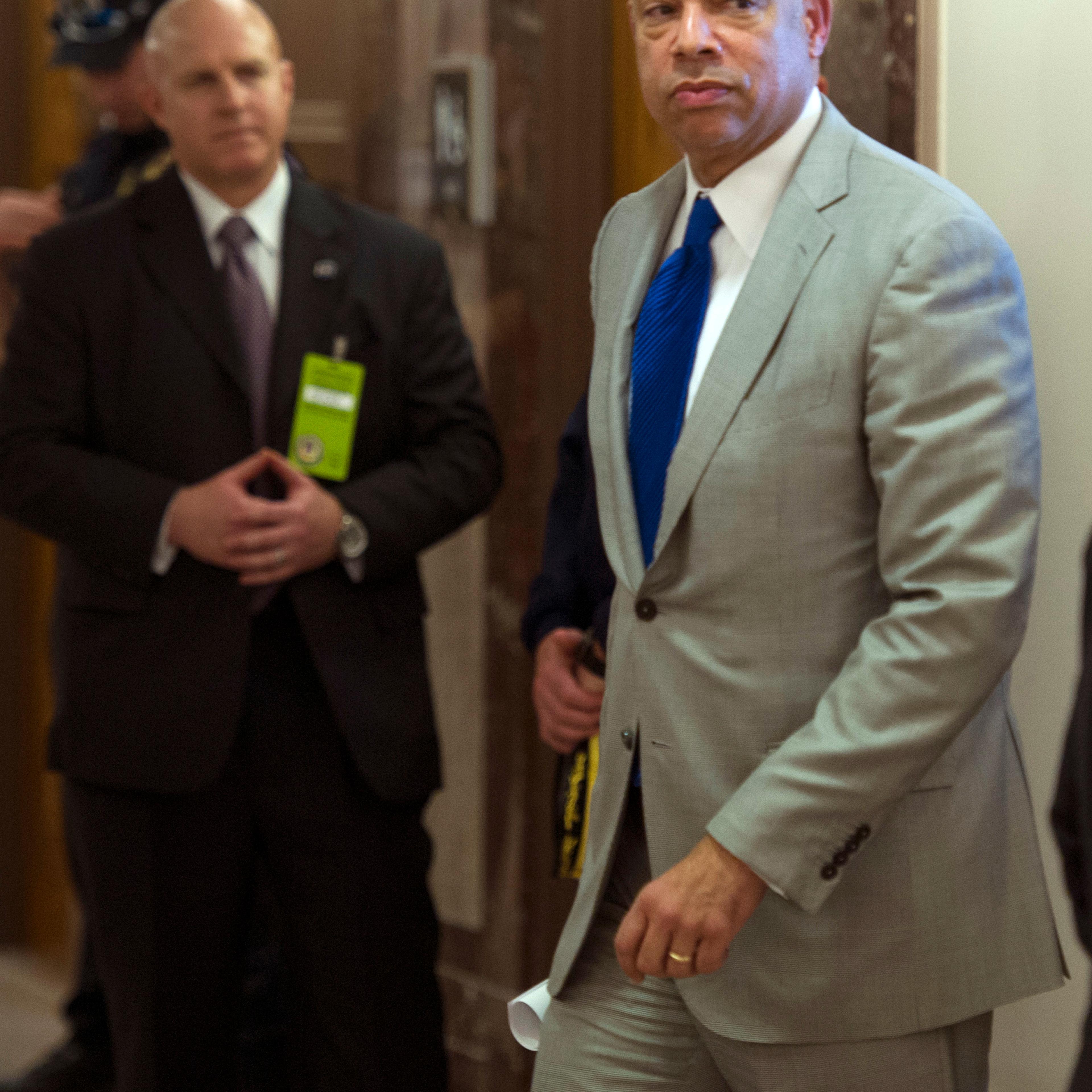 Homeland Security Secretary Jeh Johnson walks to a hearing room to answer questions before a closed meeting of the Senate Homeland Security Committee in Washington, D.C., on April 1, 2014.