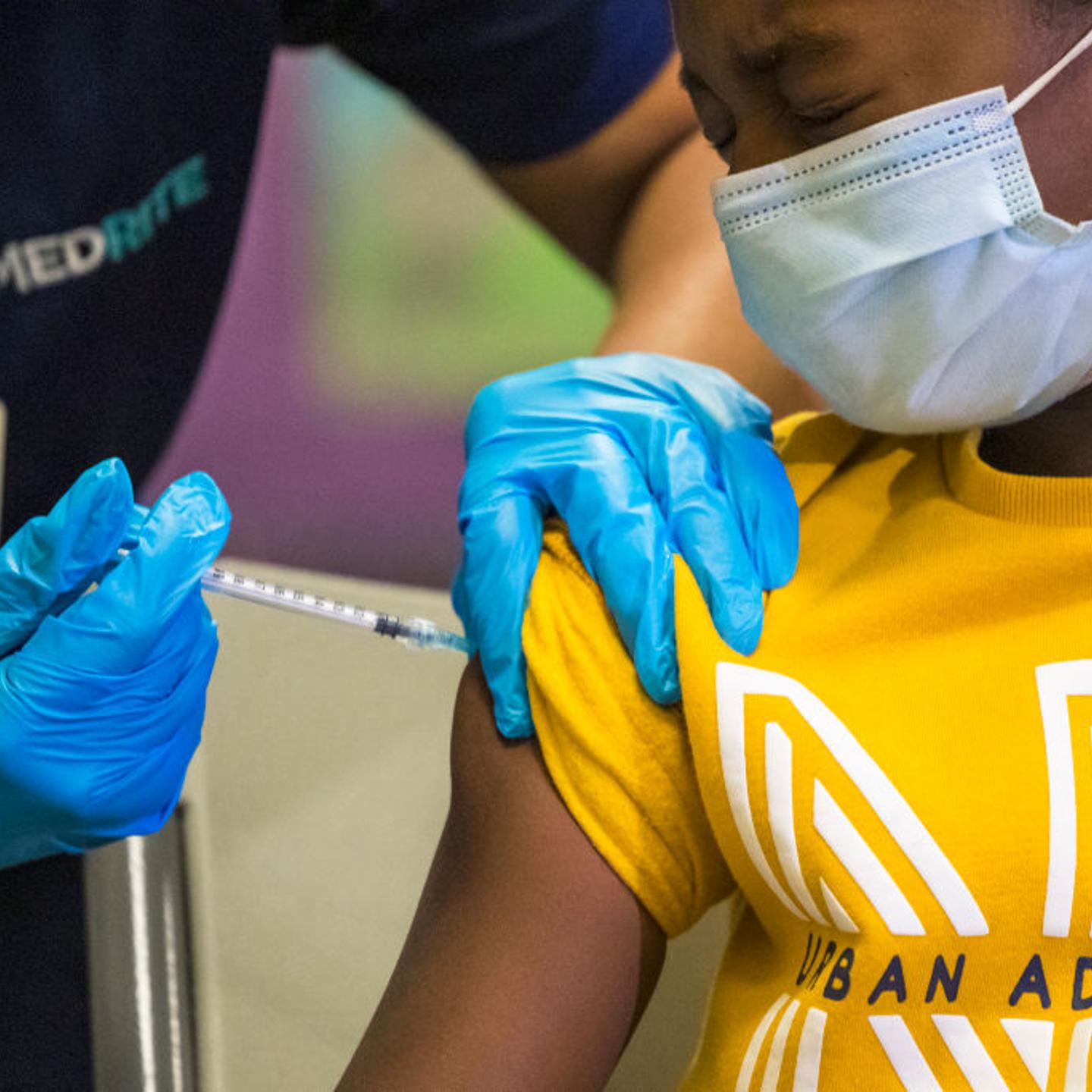 An 8-year old winces as he receives a COVID-19 shot at a vaccination event at a New York City public school on Nov. 8, 2021.