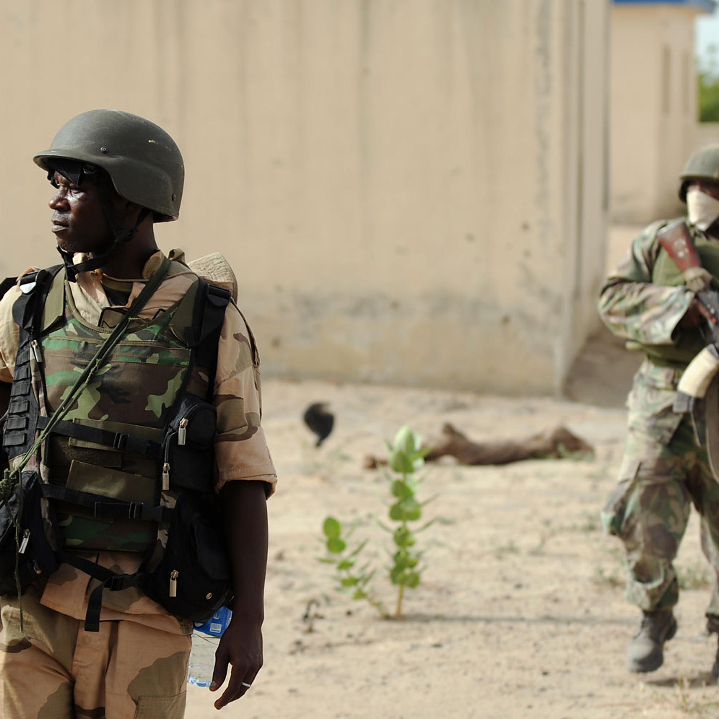 Nigerian soldiers patrol in the north of Borno state close to a Islamist extremist group Boko Haram former camp on June 5, 2013 near Maiduguri.