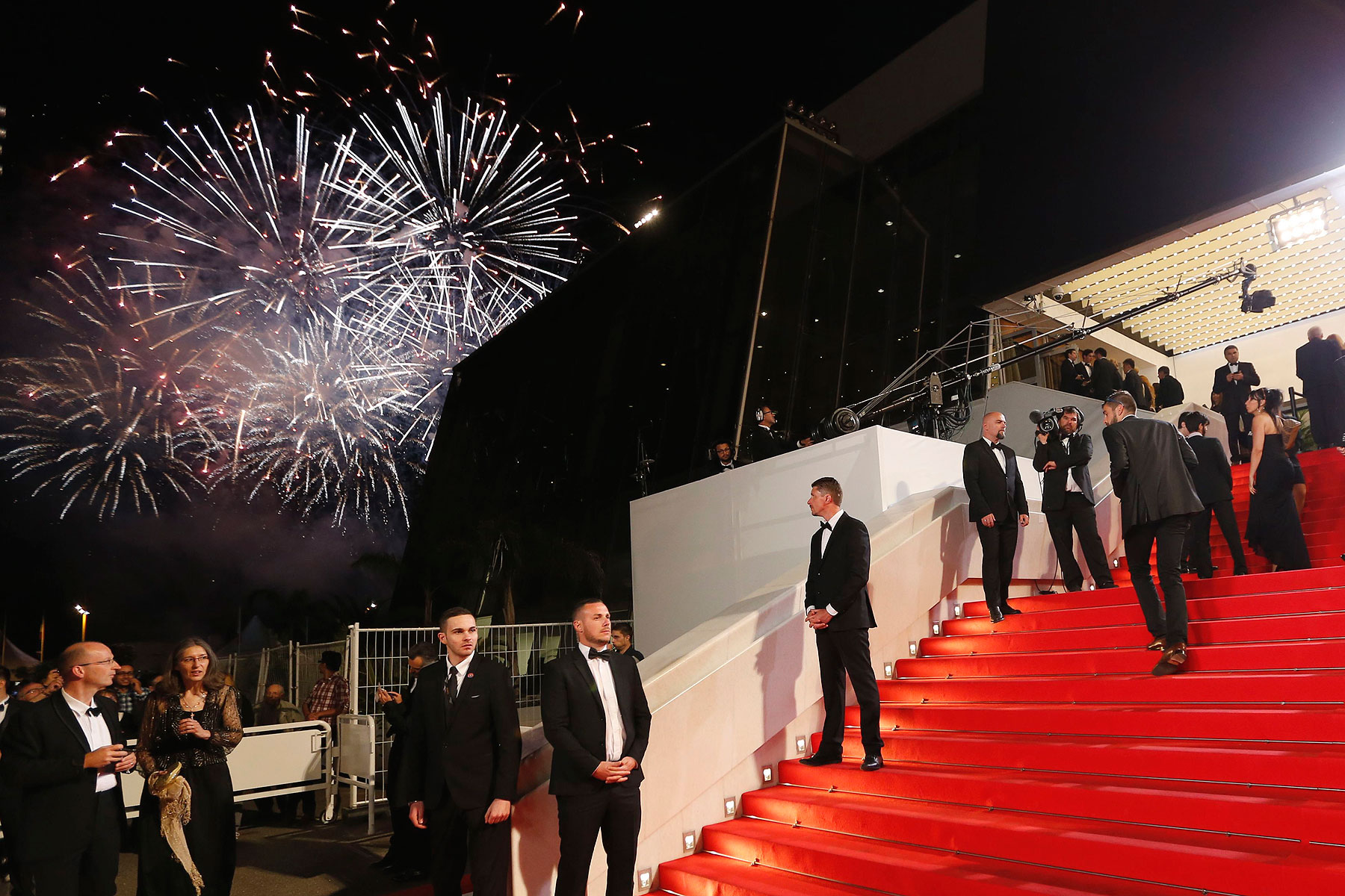 Guests walk on the red carpet during a fireworks show as they arrive for the screening of the film <i>Timbuktu</i> in competition at the 67th Cannes Film Festival in Cannes May 15, 2014