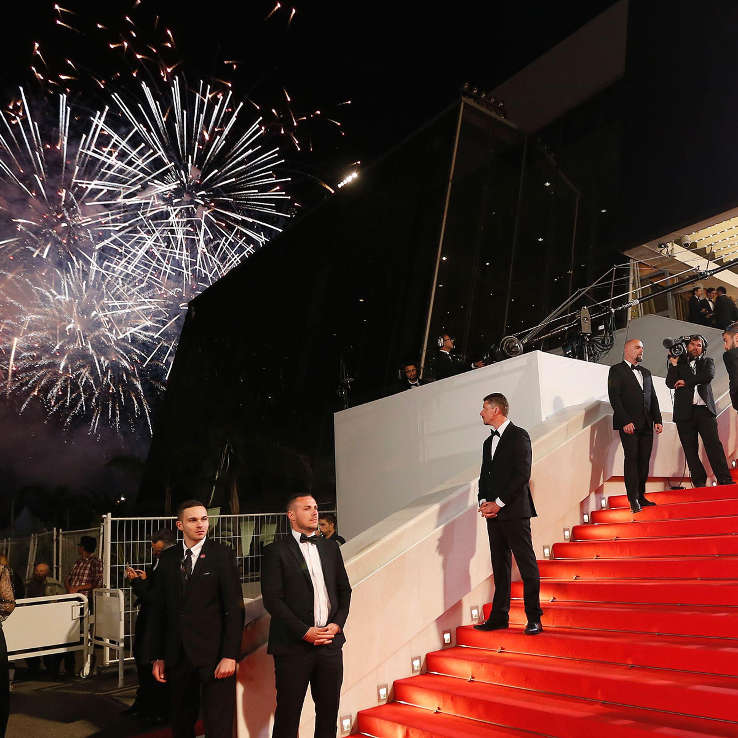 Guests walk on the red carpet during a fireworks show as they arrive for the screening of the film <i>Timbuktu</i> in competition at the 67th Cannes Film Festival in Cannes May 15, 2014