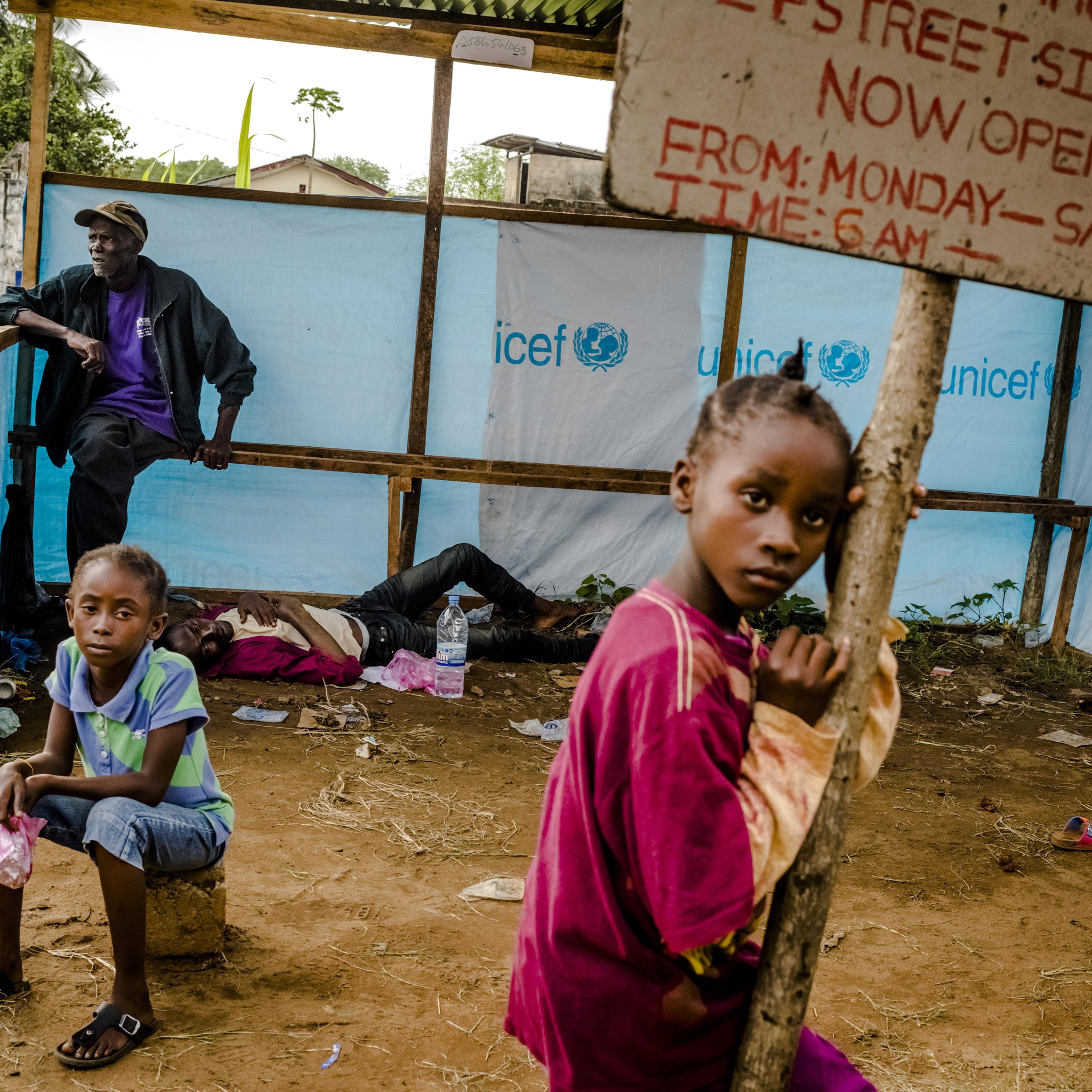 People wait to be admitted into an Ebola treatment facility in Monrovia, Liberia, on Sept. 5, 2014.