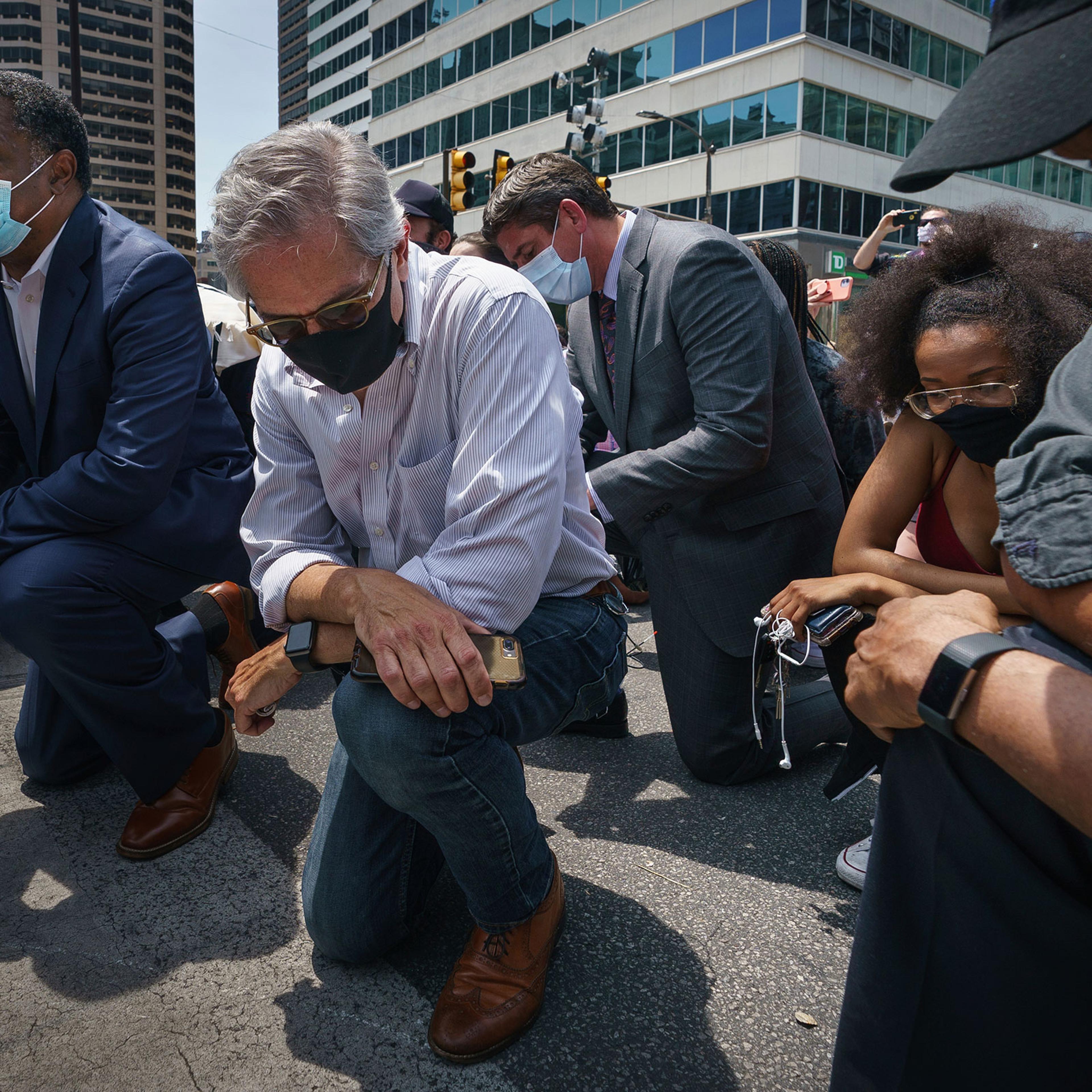 Philadelphia District Attorney Larry Krasner takes a knee in honor of the memory of George Floyda