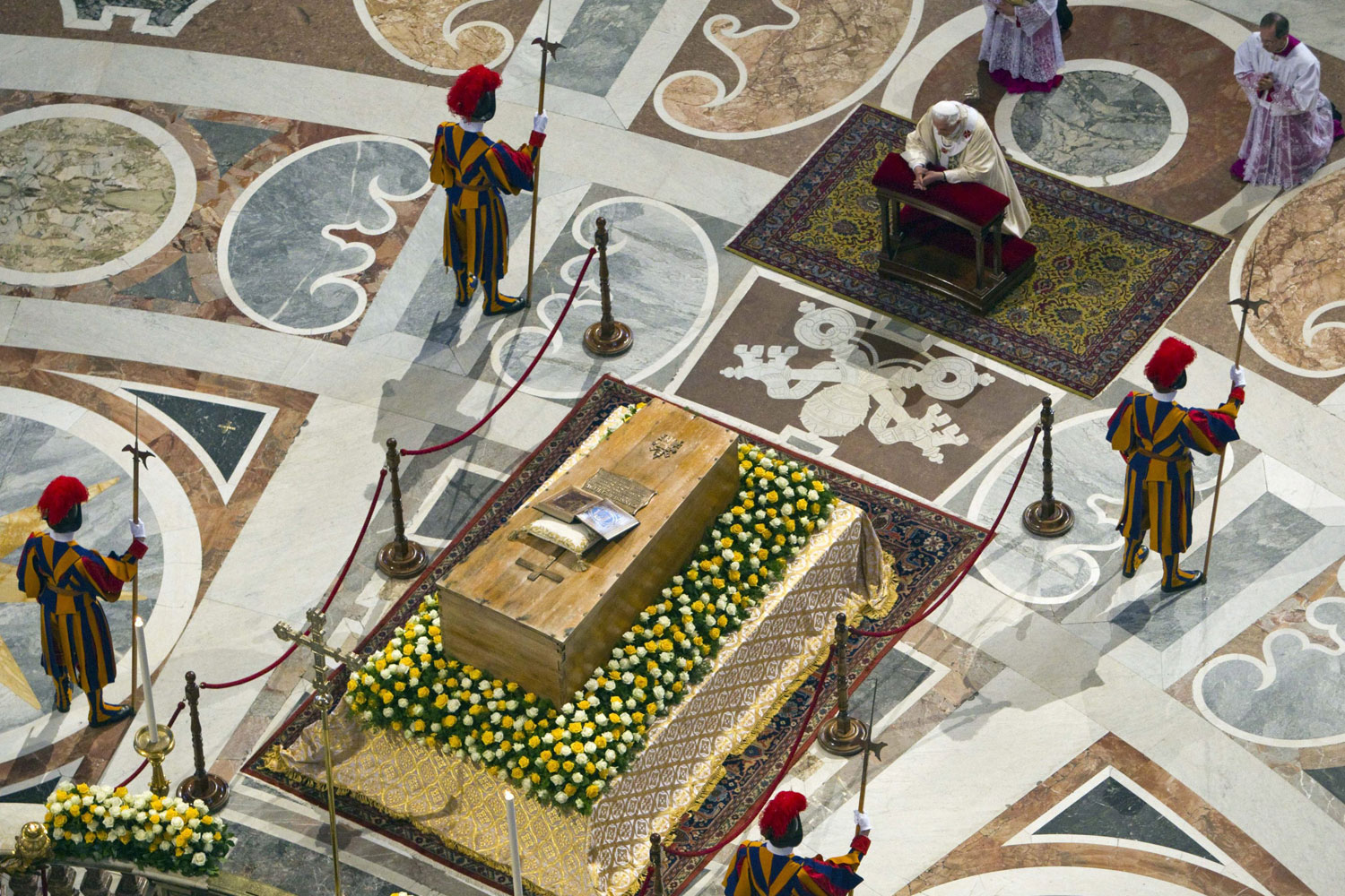 May 01, 2011. The remains of Pope John Paul II were exhumed for his beatification, the most important step toward sainthood. A million people showed up in St. Peter’s Square for the rites. But the most passionate pilgrim was his successor, Benedict XVI, kneeling before John Paul’s coffin, heir to and prisoner of the charismatic Pontiff’s historic and controversial legacies. —Stephan Faris