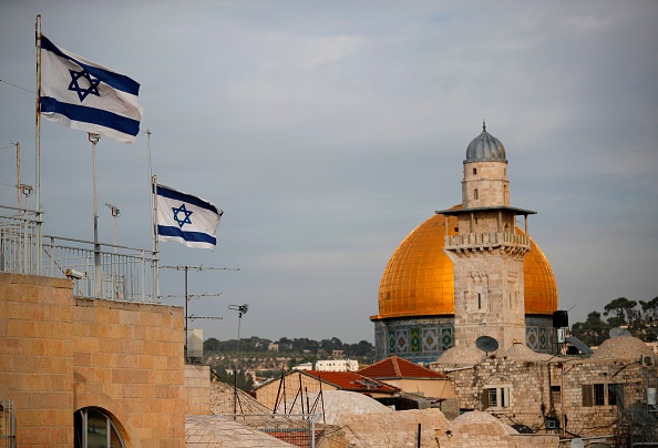Israeli flags fly near the Dome of the Rock in the Al-Aqsa mosque compound on December 5, 2017. The EU's diplomatic chief Federica Mogherini said that the status of Jerusalem must be resolved "through negotiations", as US President Donald Trump mulls rec